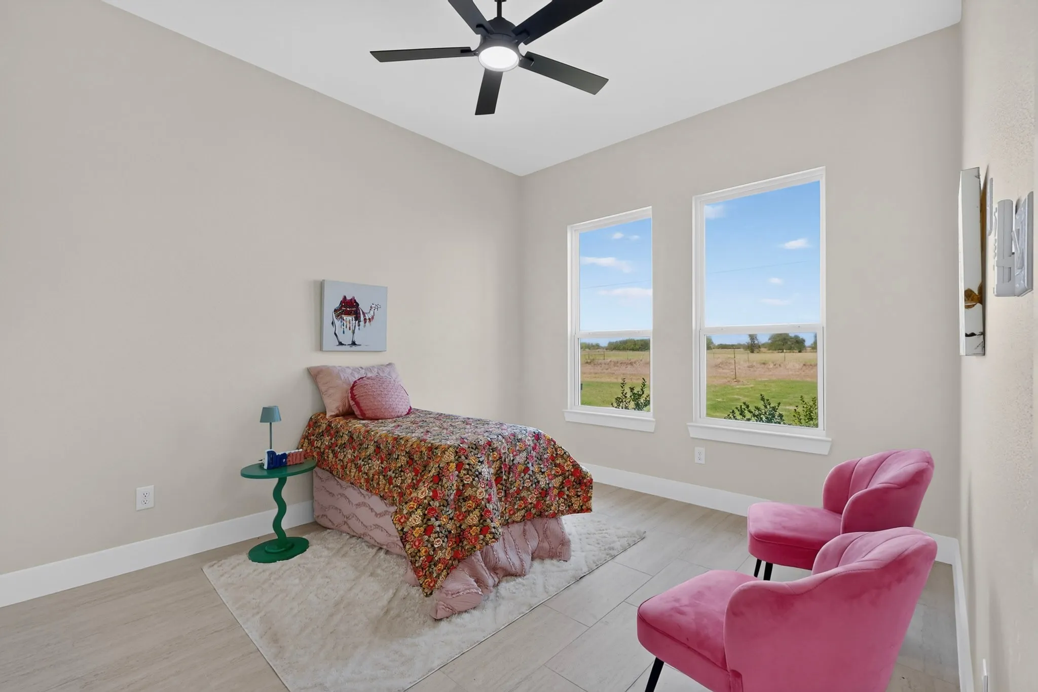 Recessed lighting, wood-finish flooring, two large windows, and a ceiling fan with integrated lighting