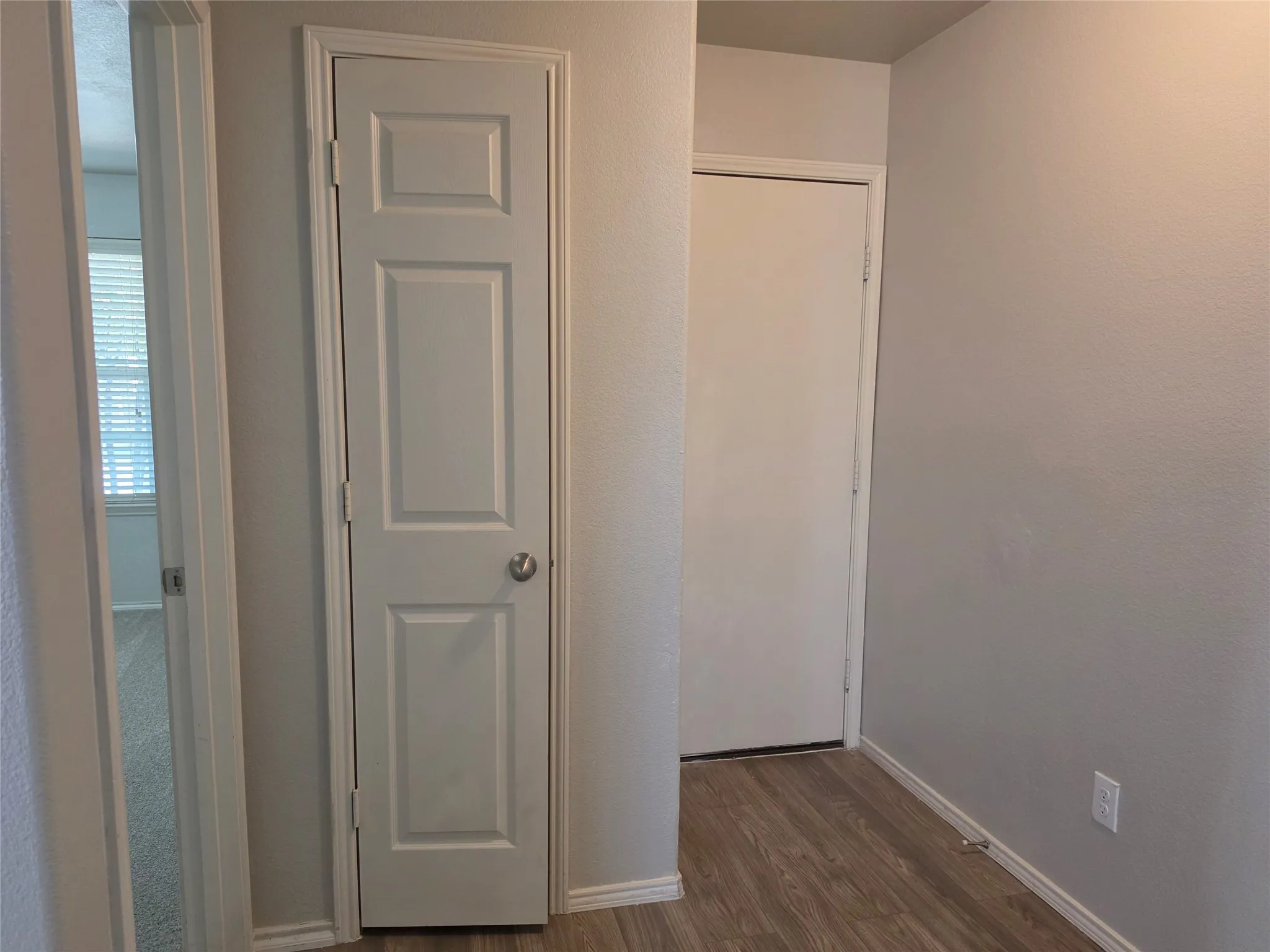 Hall to bedrooms and access to garage