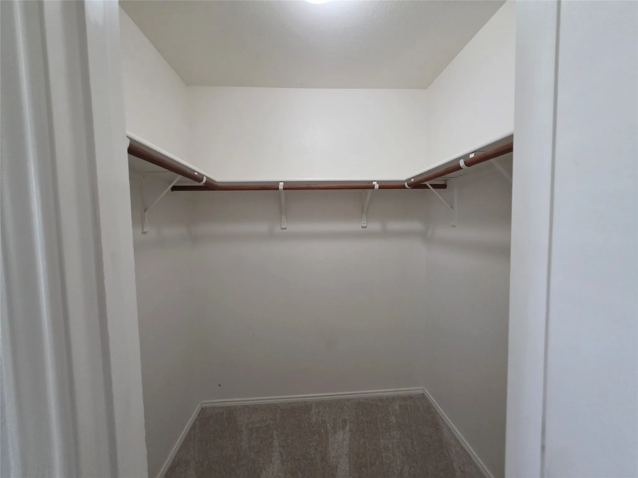 Primary bedroom walk-in closet