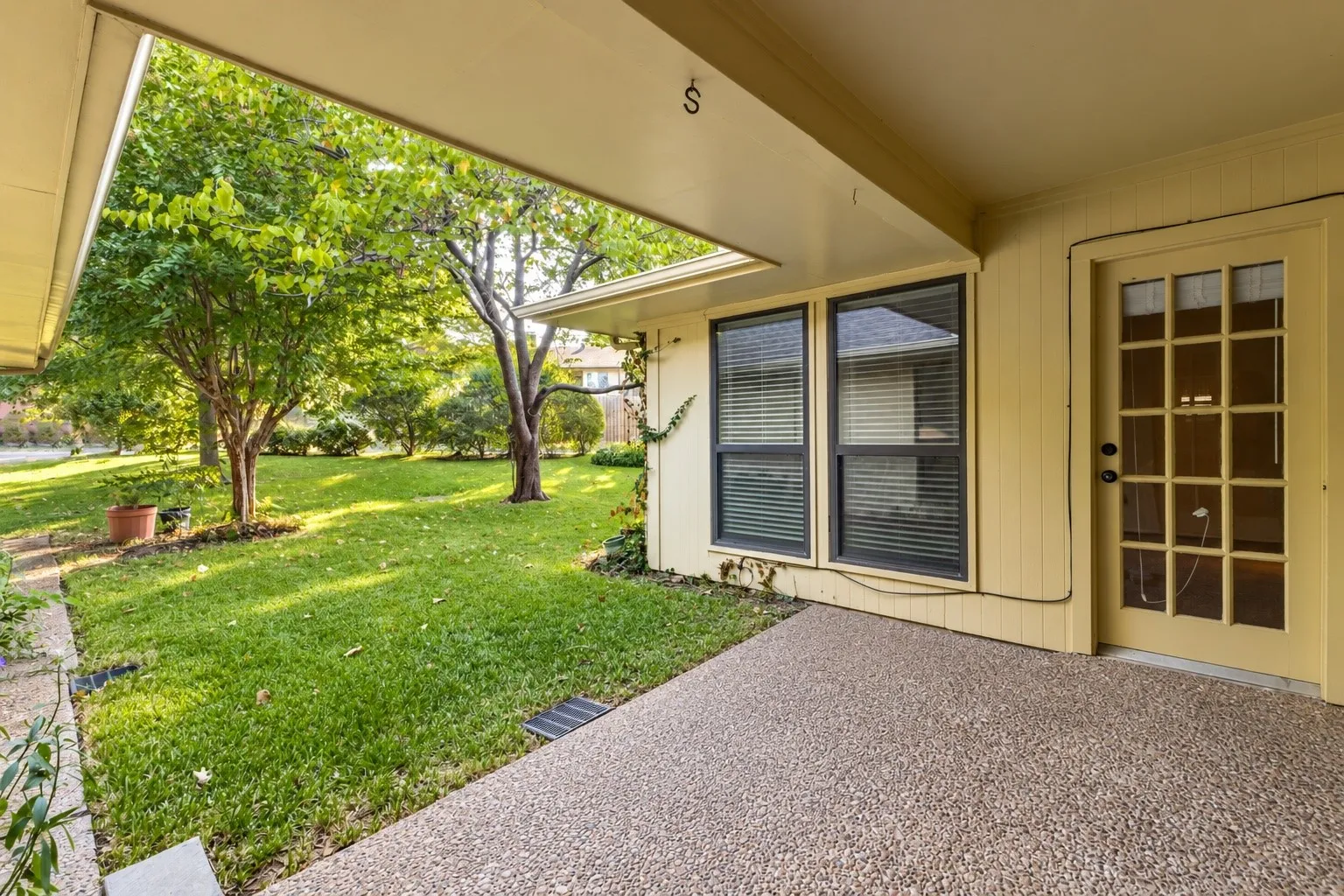 This patio comes off the living room and the door leads into the primary bedroom.