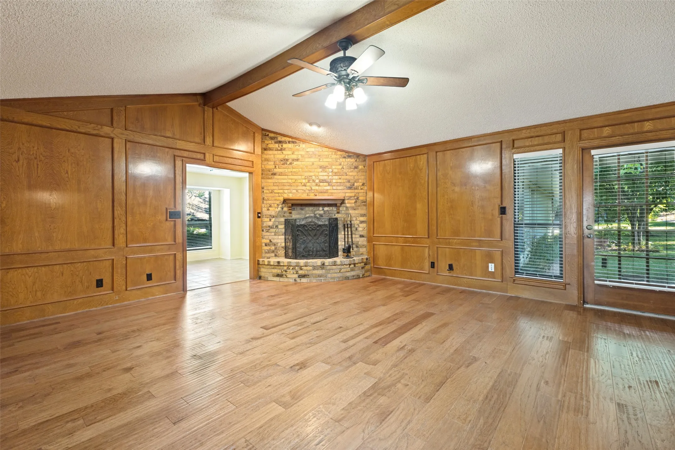 Family room has lots of space, exit to the yard and a wood burning fireplace.