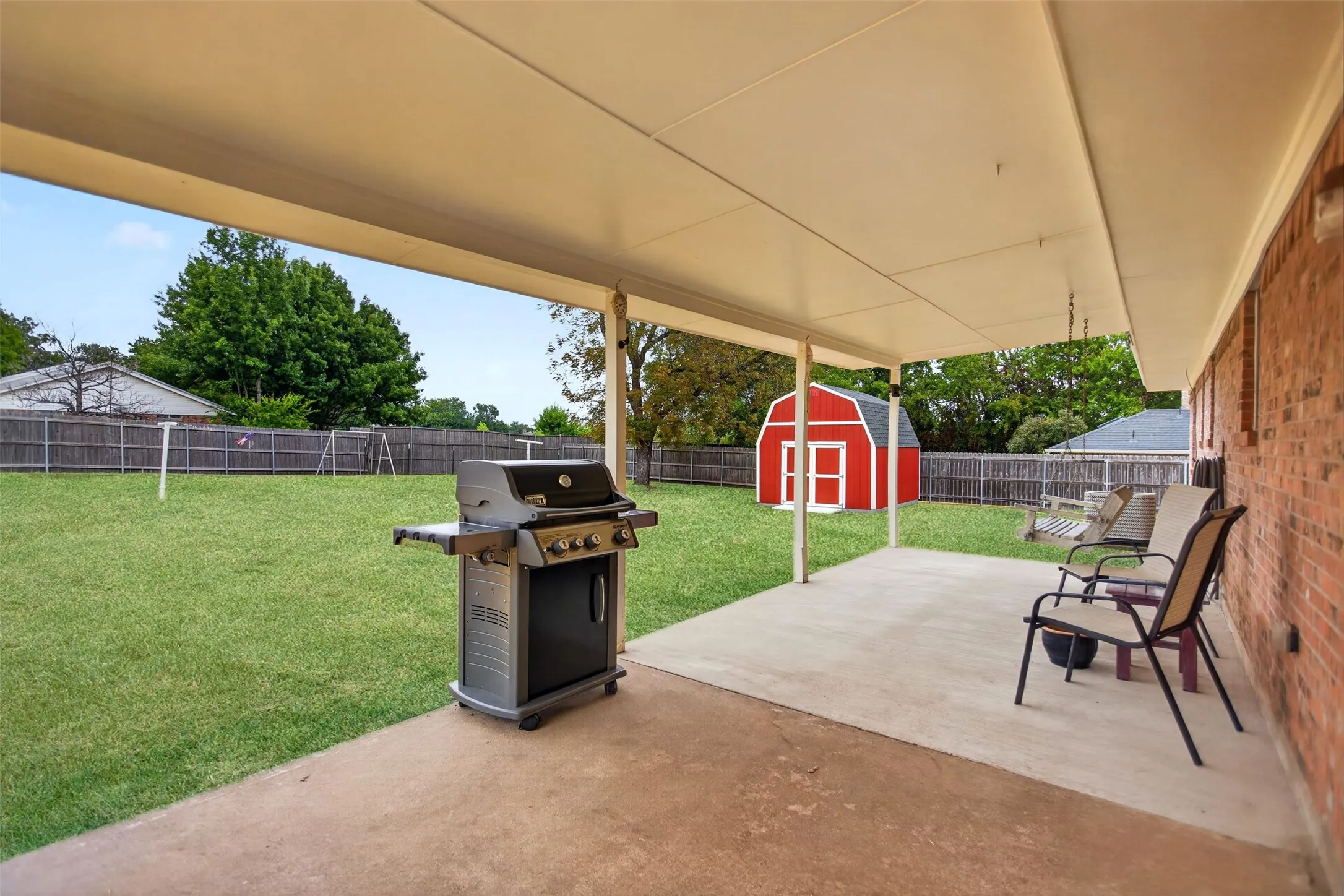 Expansive concrete patio with a covered outdoor area