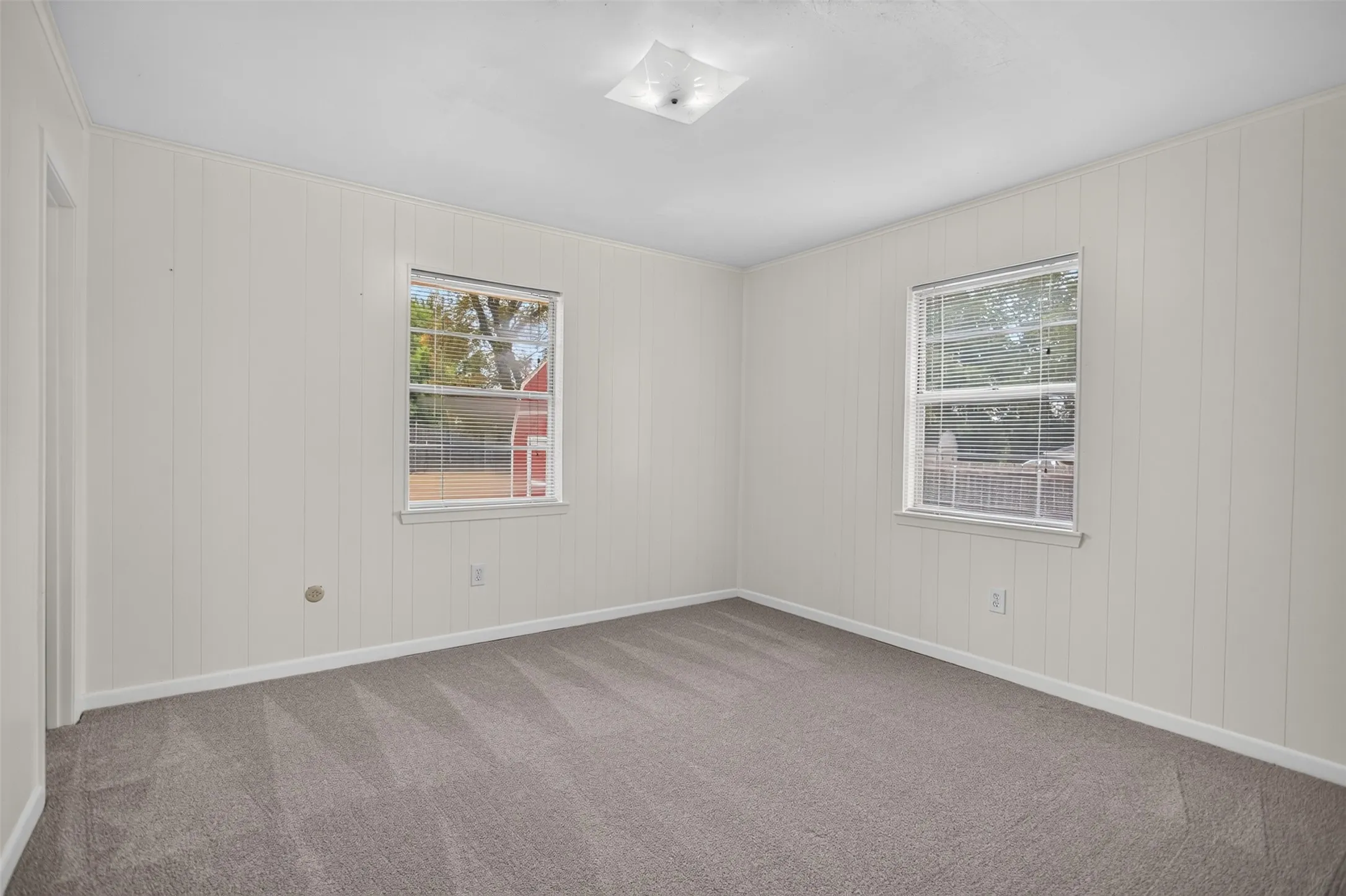 Recessed lighting and two windows with white trim