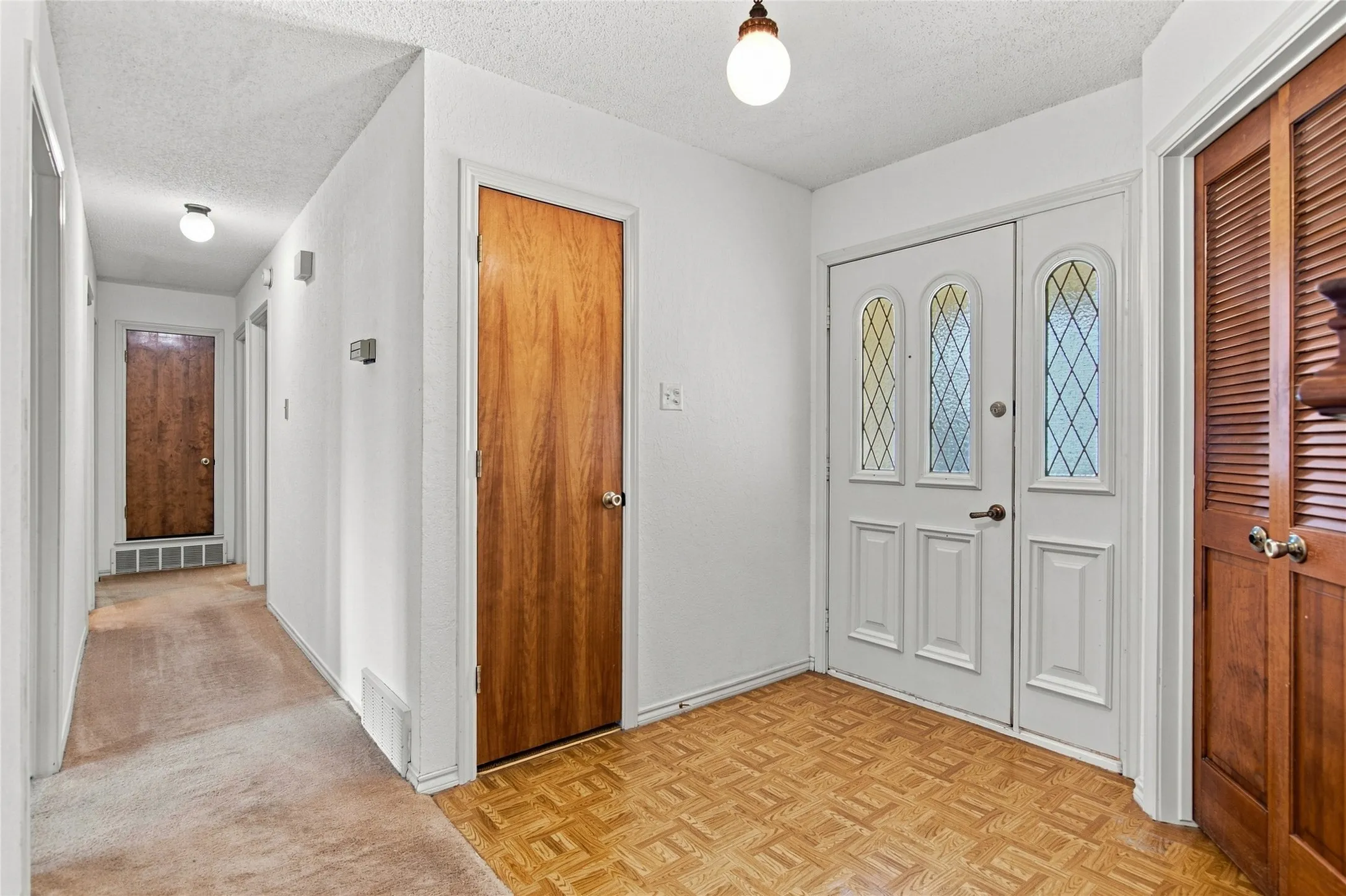 The garage is just beyond the double doors to your right.