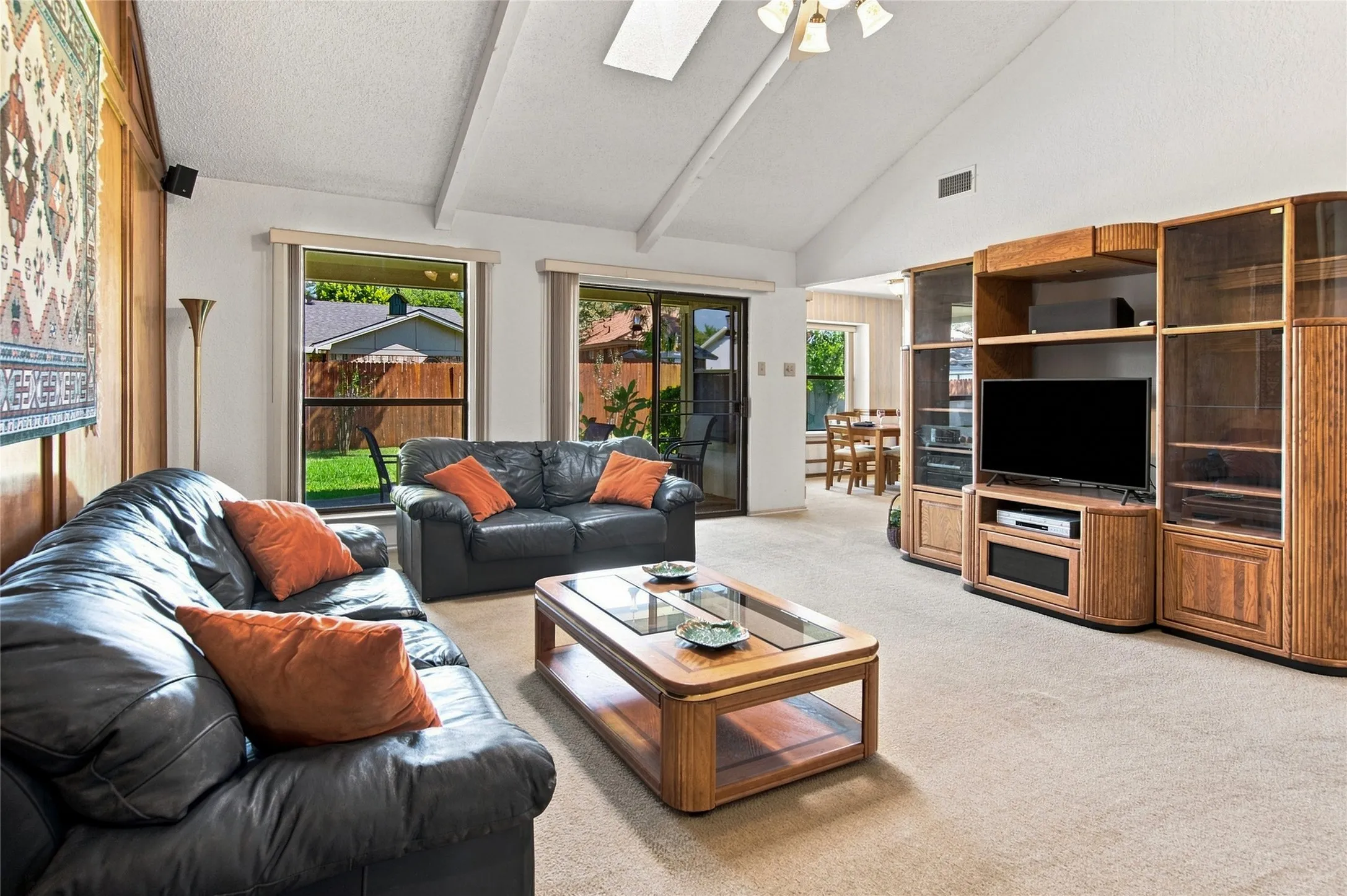 Large windows and glass doors fill the room with natural light and bring the beauty of the backyard inside.