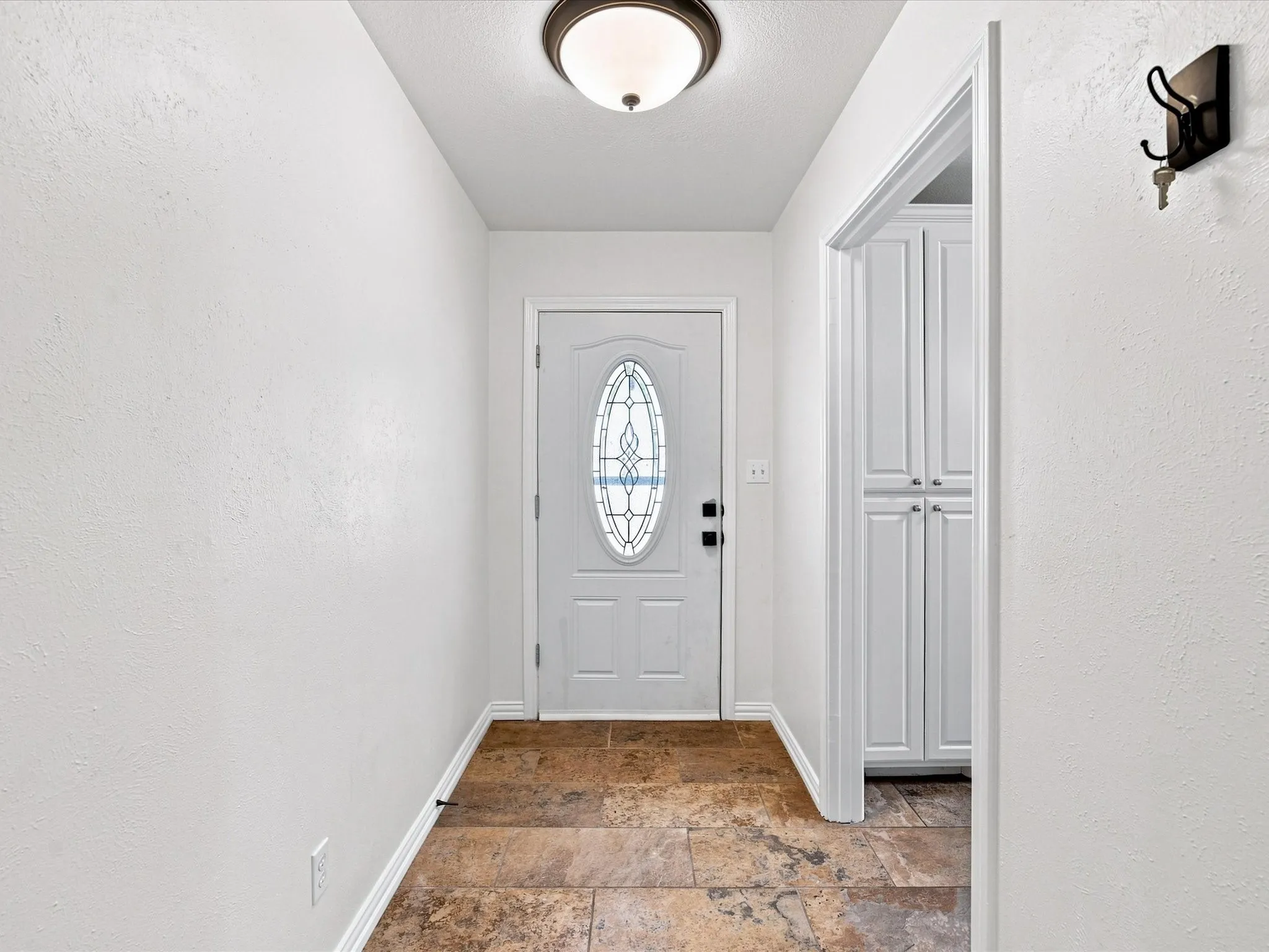 As you enter the door, the kitchen is to your left