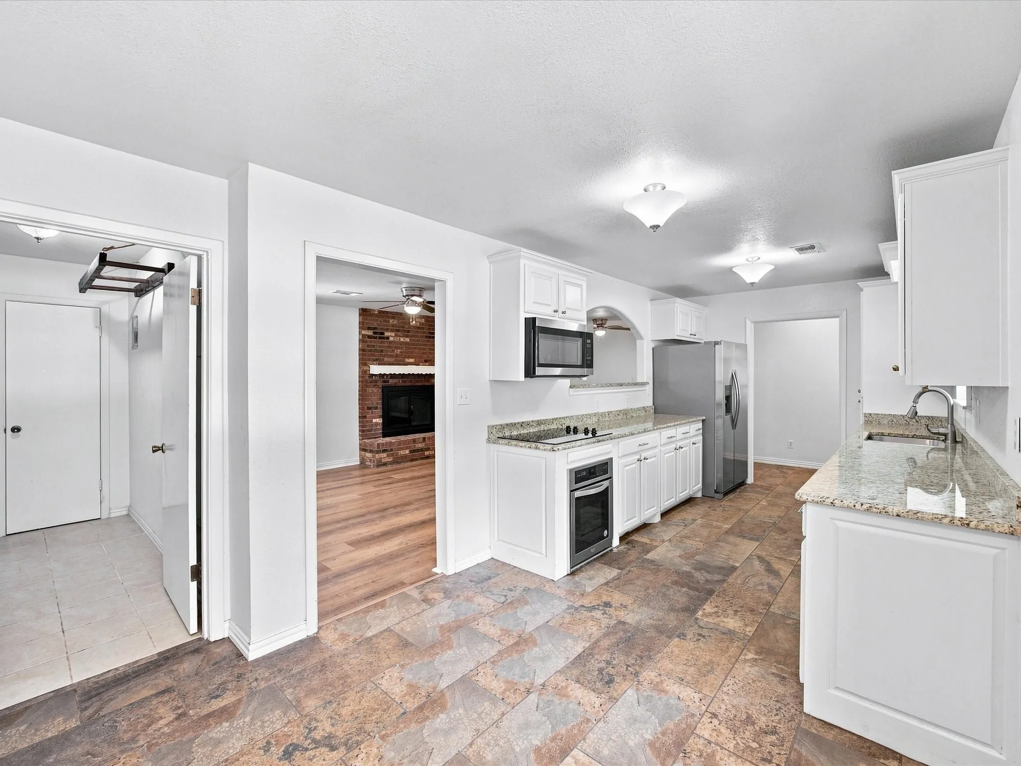 View of laundry room and entry to living room