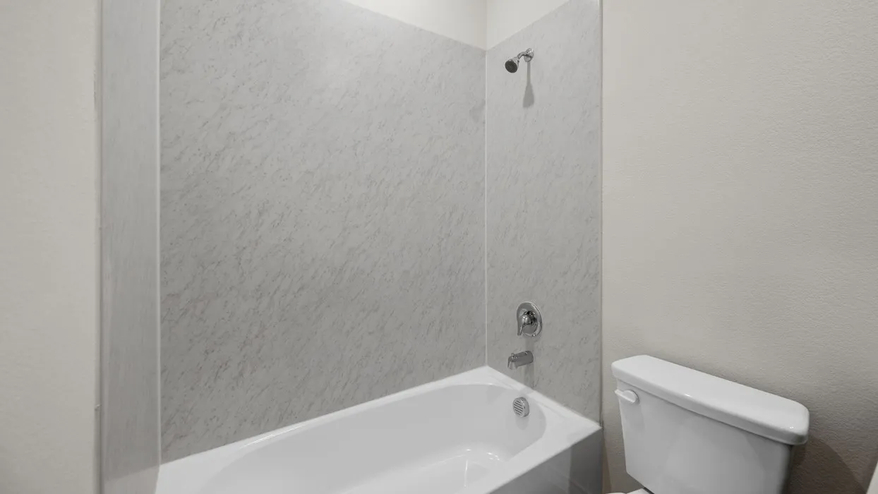 Bathtub with white surround and chrome fixtures