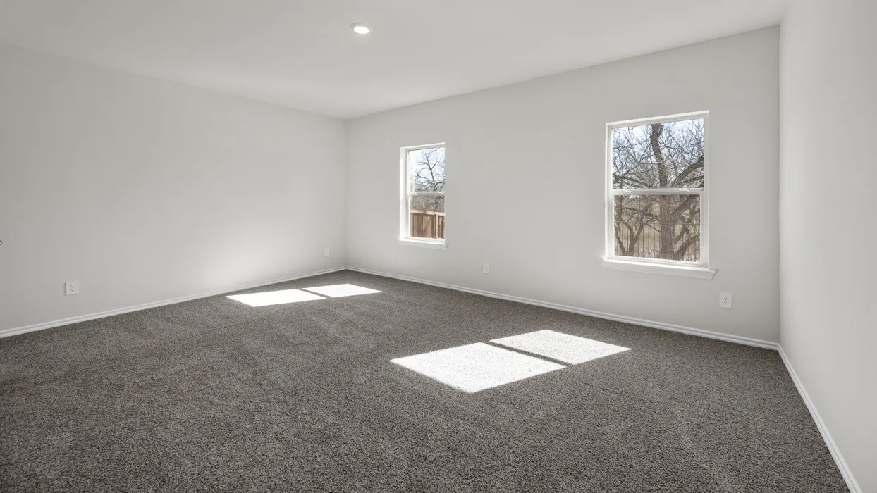 Spacious room featuring gray carpeting, white walls, two windows, and a recessed ceiling light