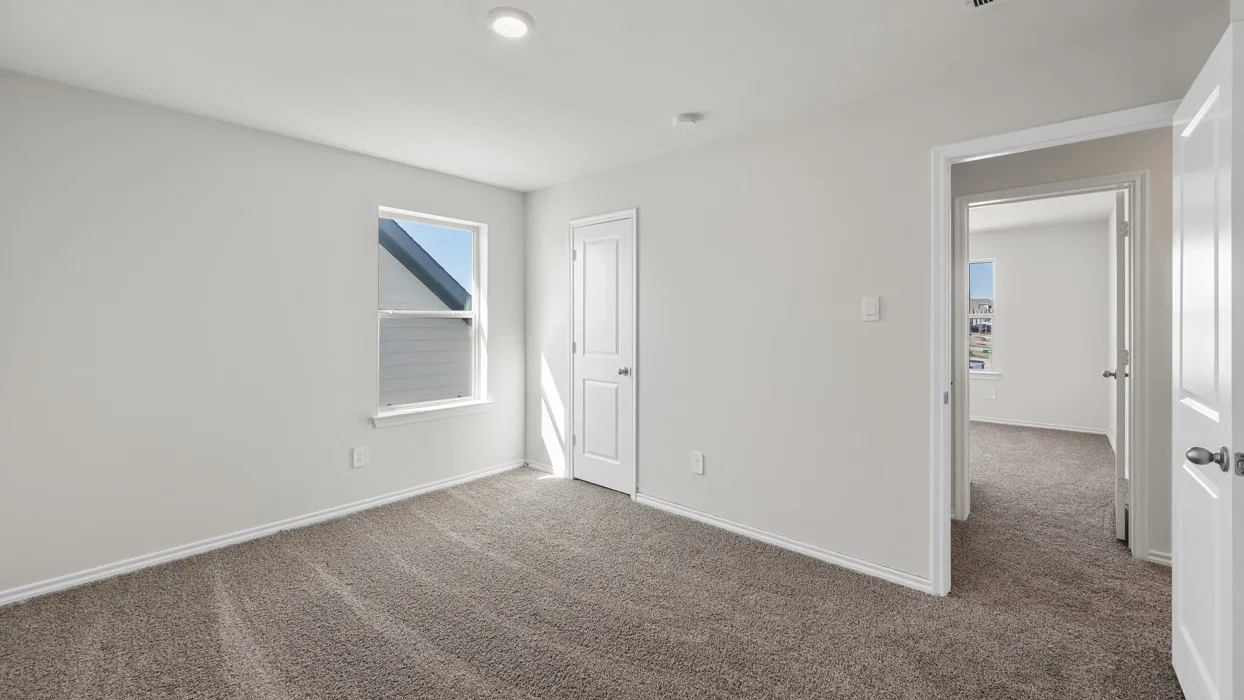 Carpeted room featuring a single window, recessed lighting, and a white paneled door