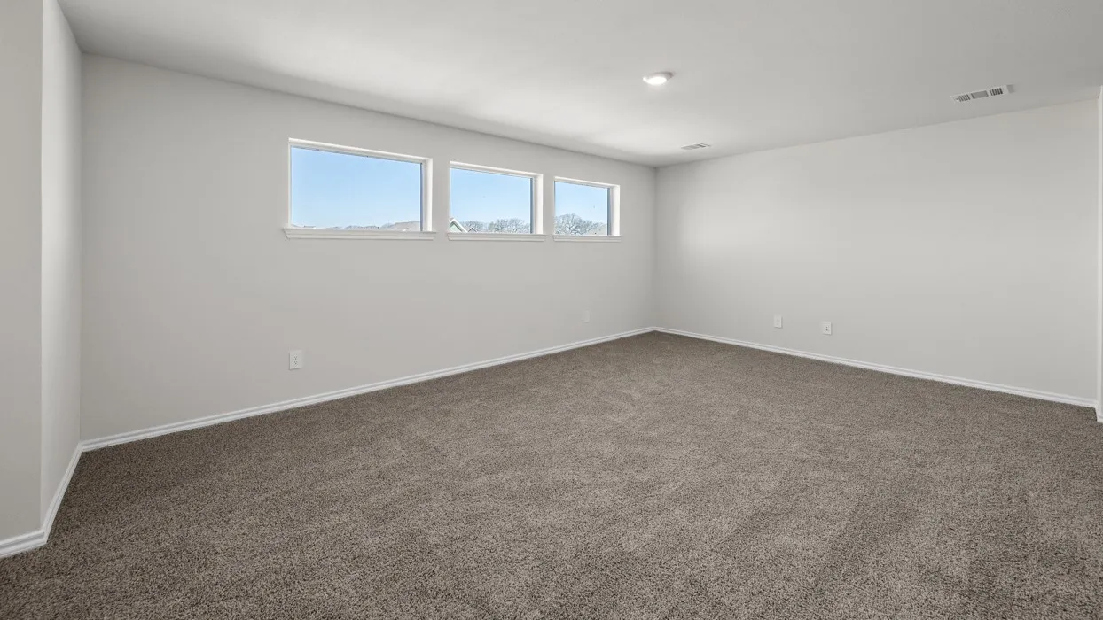 Neutral-toned carpeting, white walls, and three horizontal windows