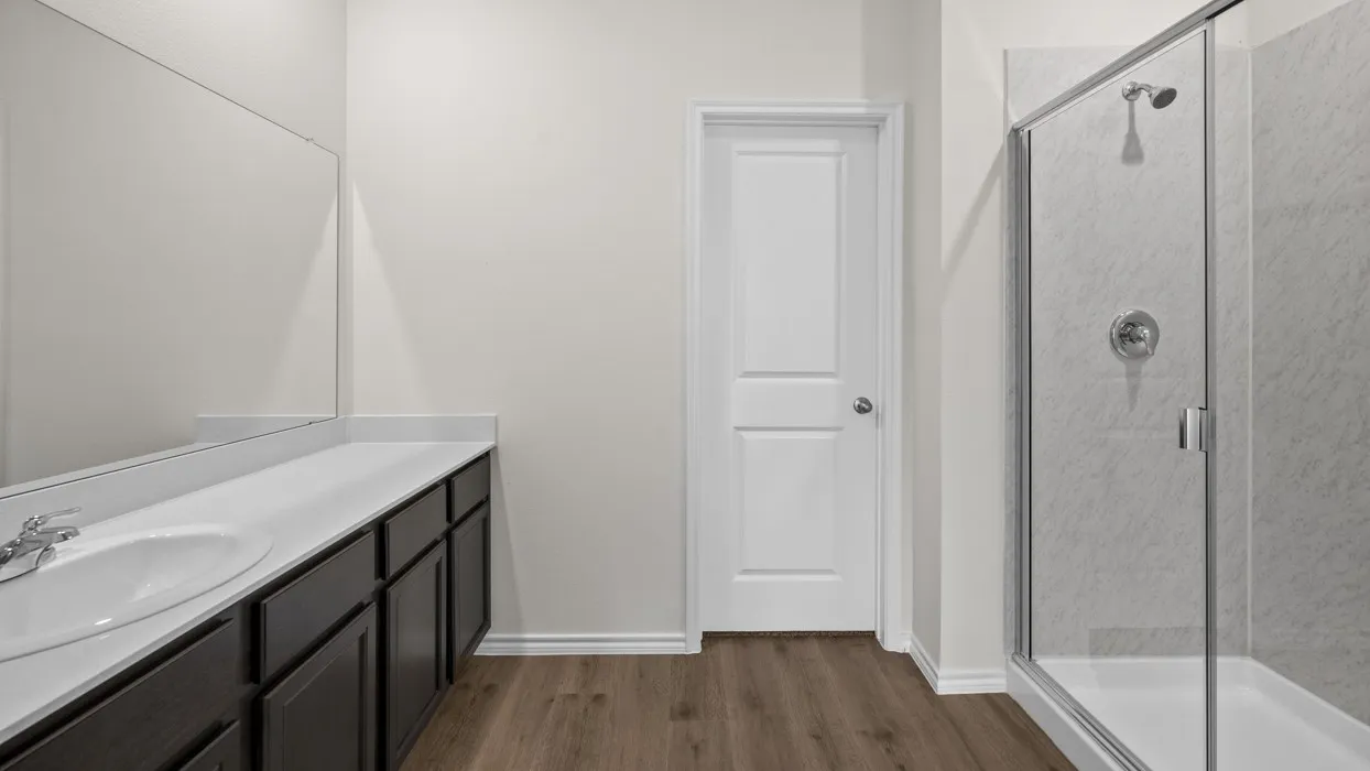 Expansive vanity with dark wood-finish cabinetry, white countertop, and integrated sink