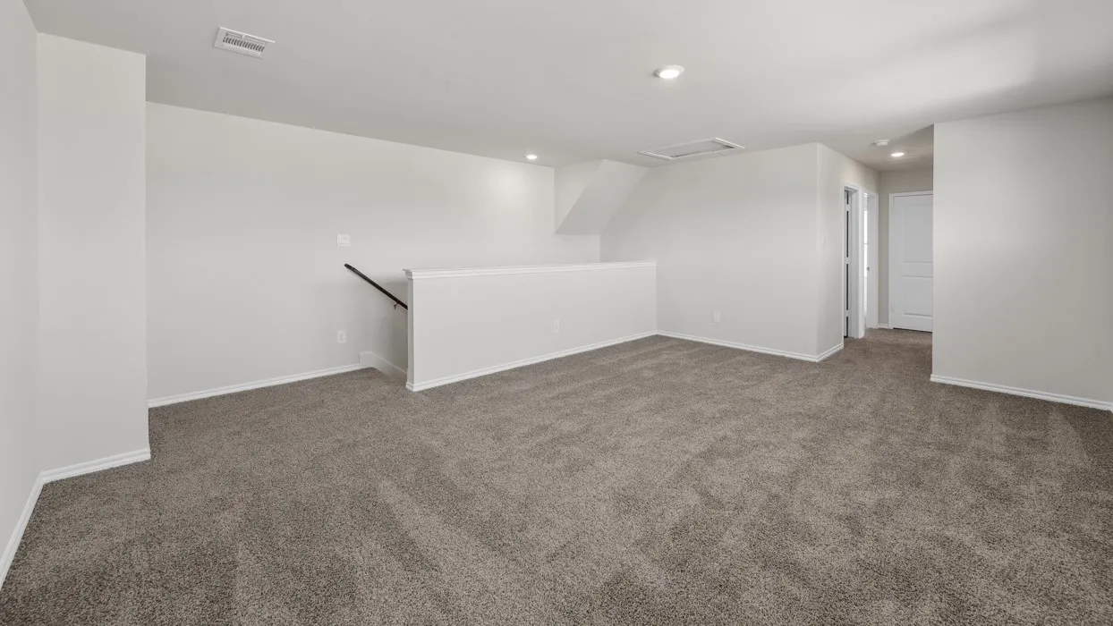 Spacious bonus room featuring plush carpeting, recessed lighting, and a white interior color palette