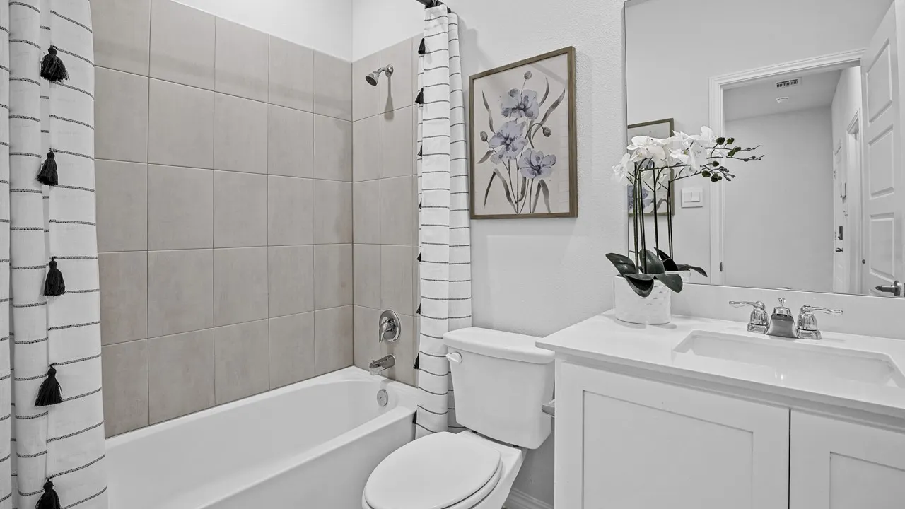 Integrated bathtub and shower with light-toned tile surround