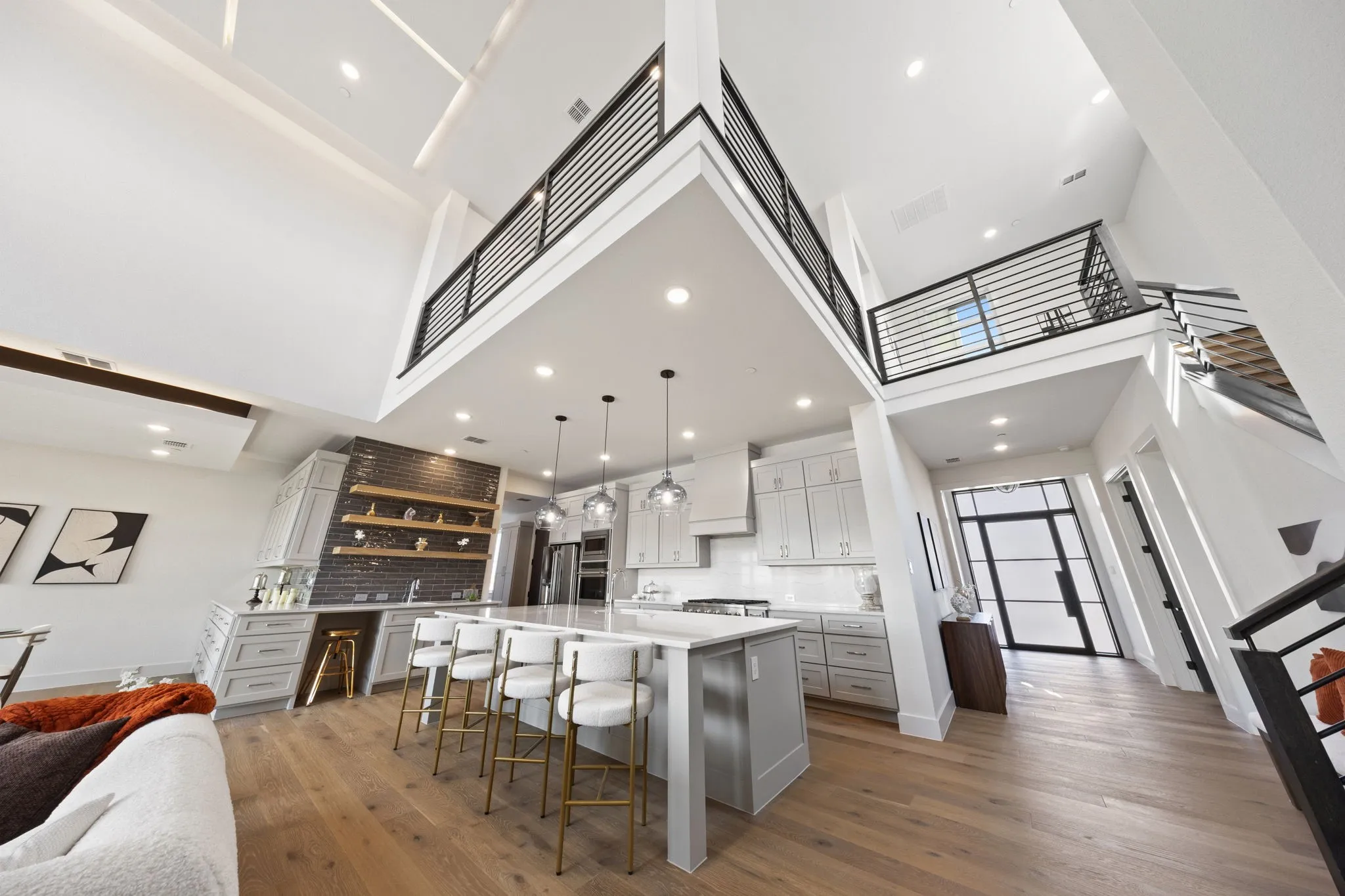 Spacious open-concept interior with high ceilings and wood-finish flooring
