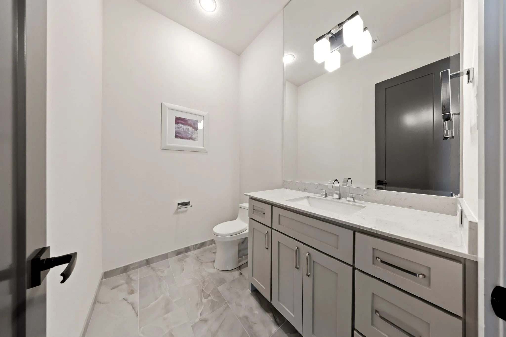 Contemporary vanity with an undermount sink, a quartz countertop, and brushed nickel hardware