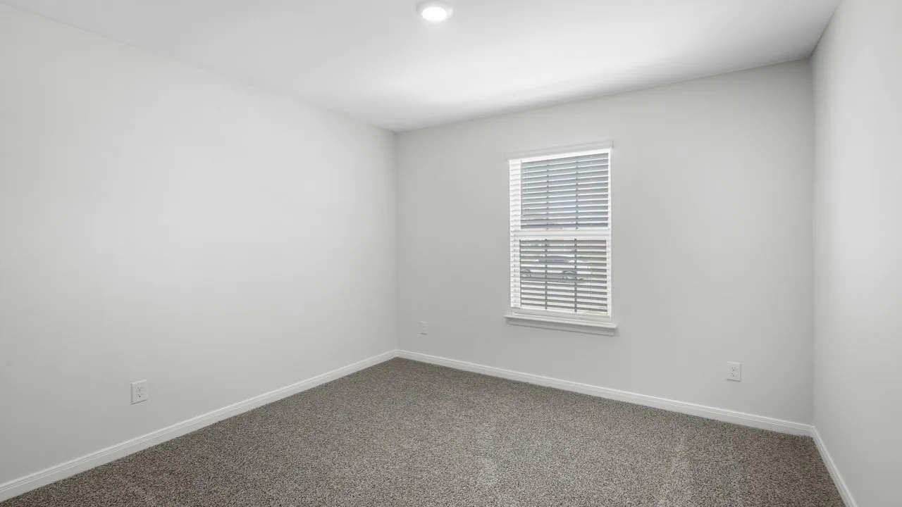 Room featuring neutral gray carpeting, white walls, and a recessed ceiling light