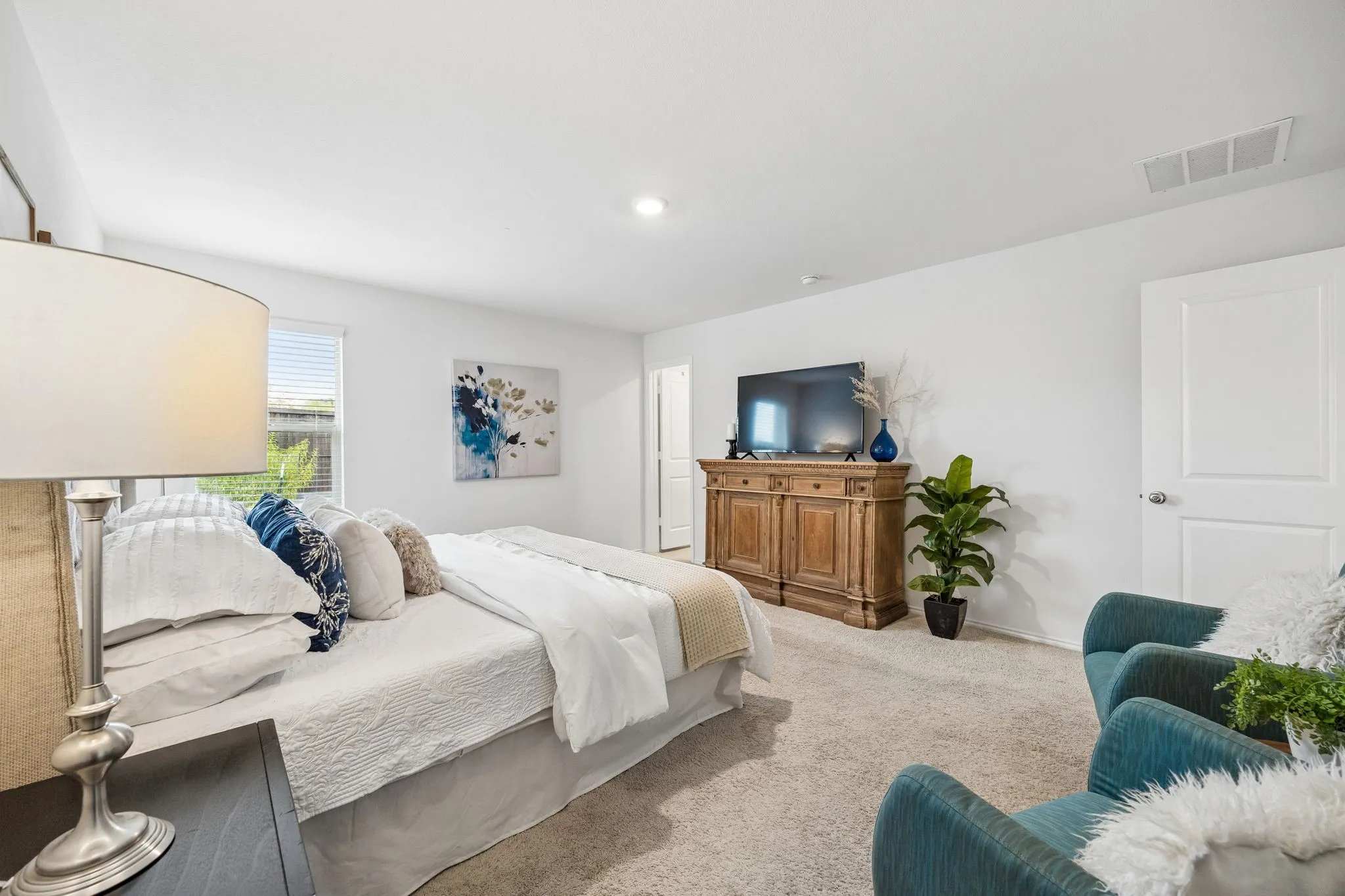 Recessed lighting, light-colored carpeting, white interior doors, and a window with blinds