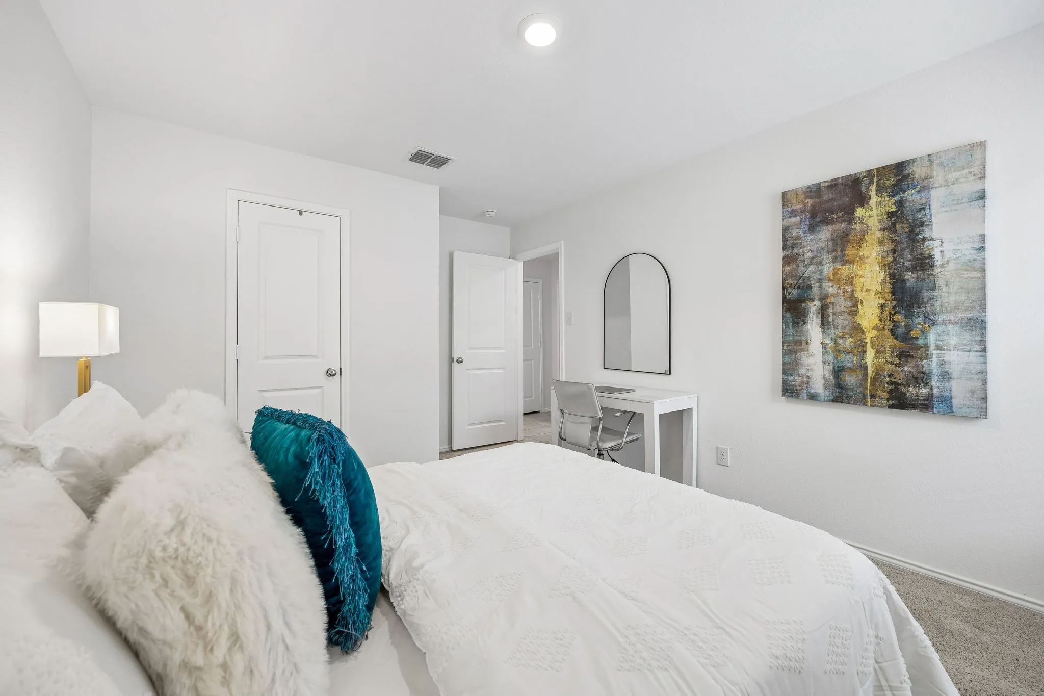 Bright primary bedroom featuring neutral finishes, recessed ceiling lighting, and neutral-toned wood-finish flooring