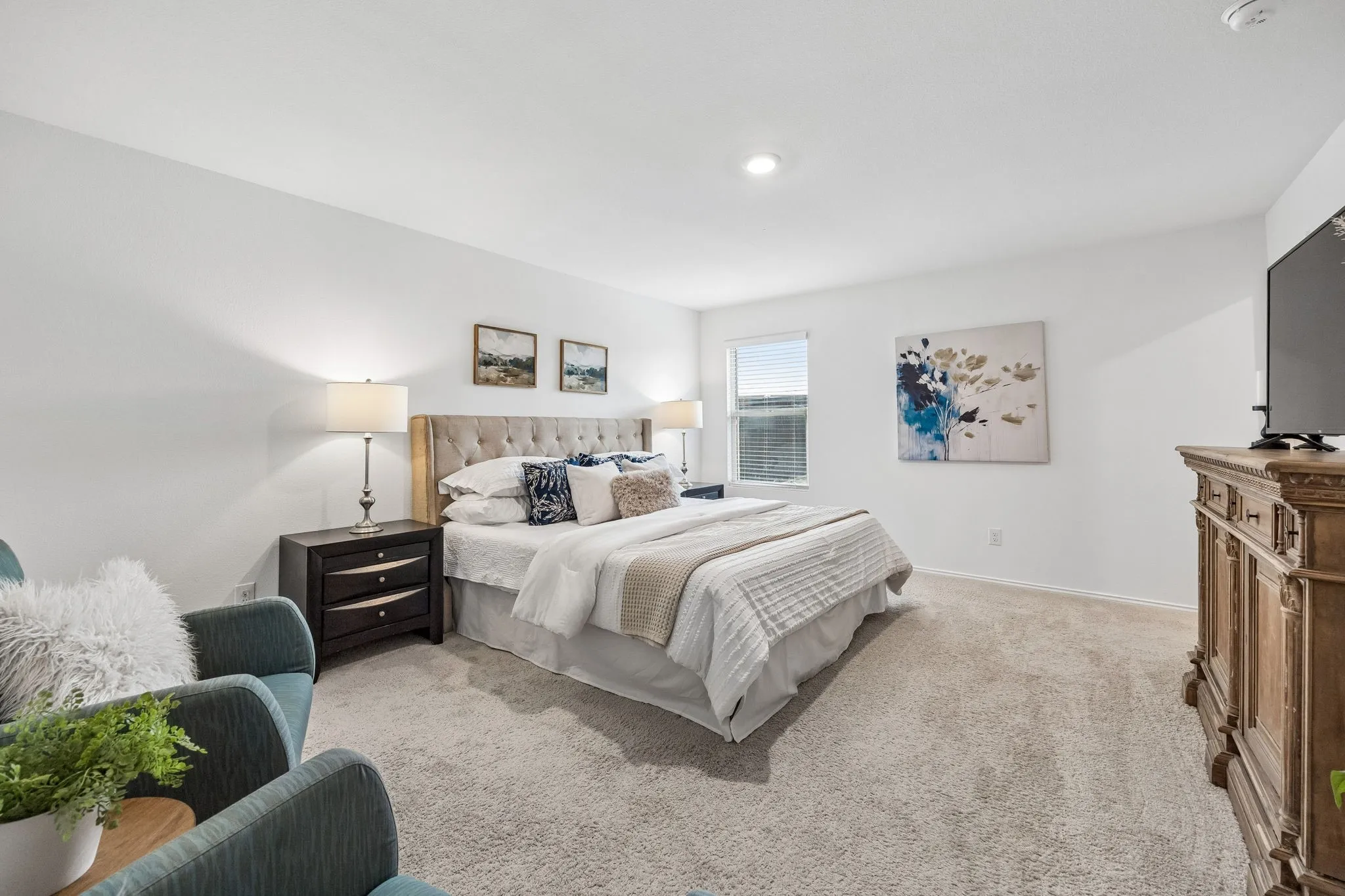 Recessed lighting, plush carpeting, a window with blinds, and a tufted headboard