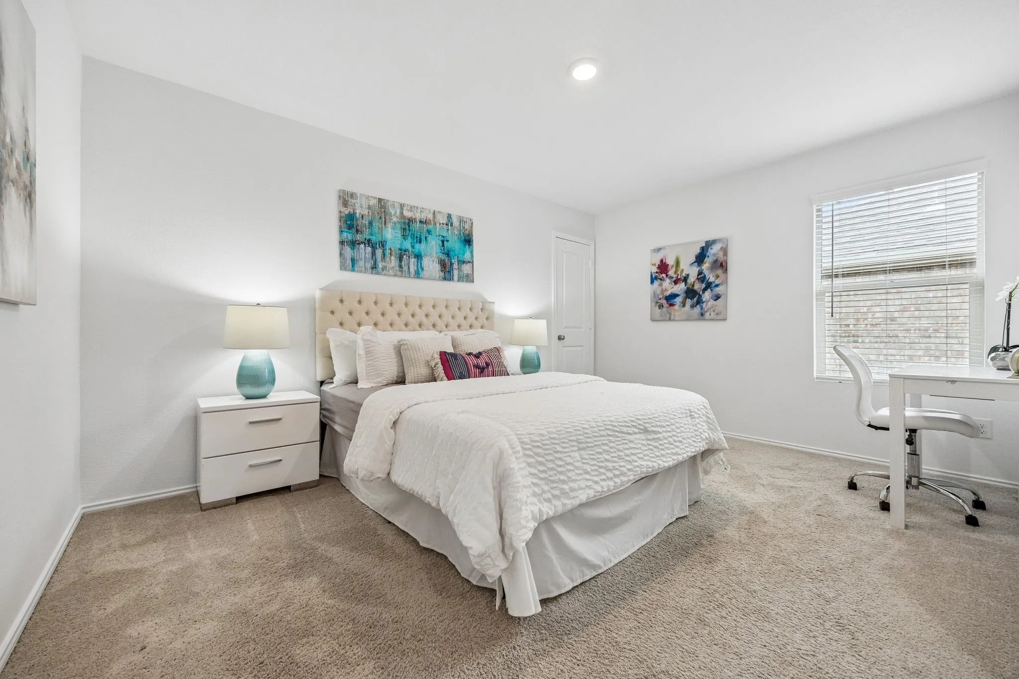 Recessed lighting, neutral tone carpeting, window with blinds, white interior door, and white painted walls