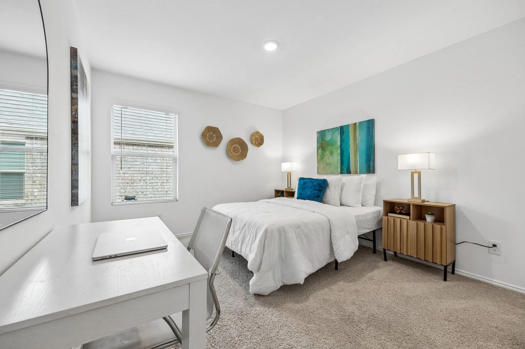 Recessed lighting, window with blinds, light-colored carpet, white walls, and a built-in desk