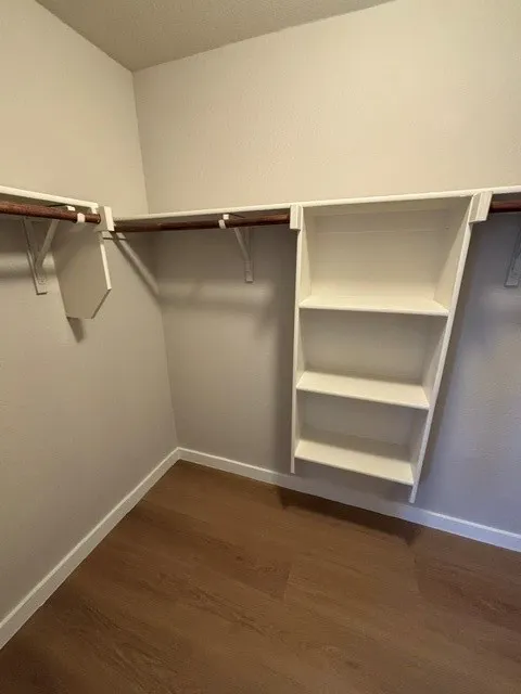 Built-in shelving, wood-finish flooring, and white trim
