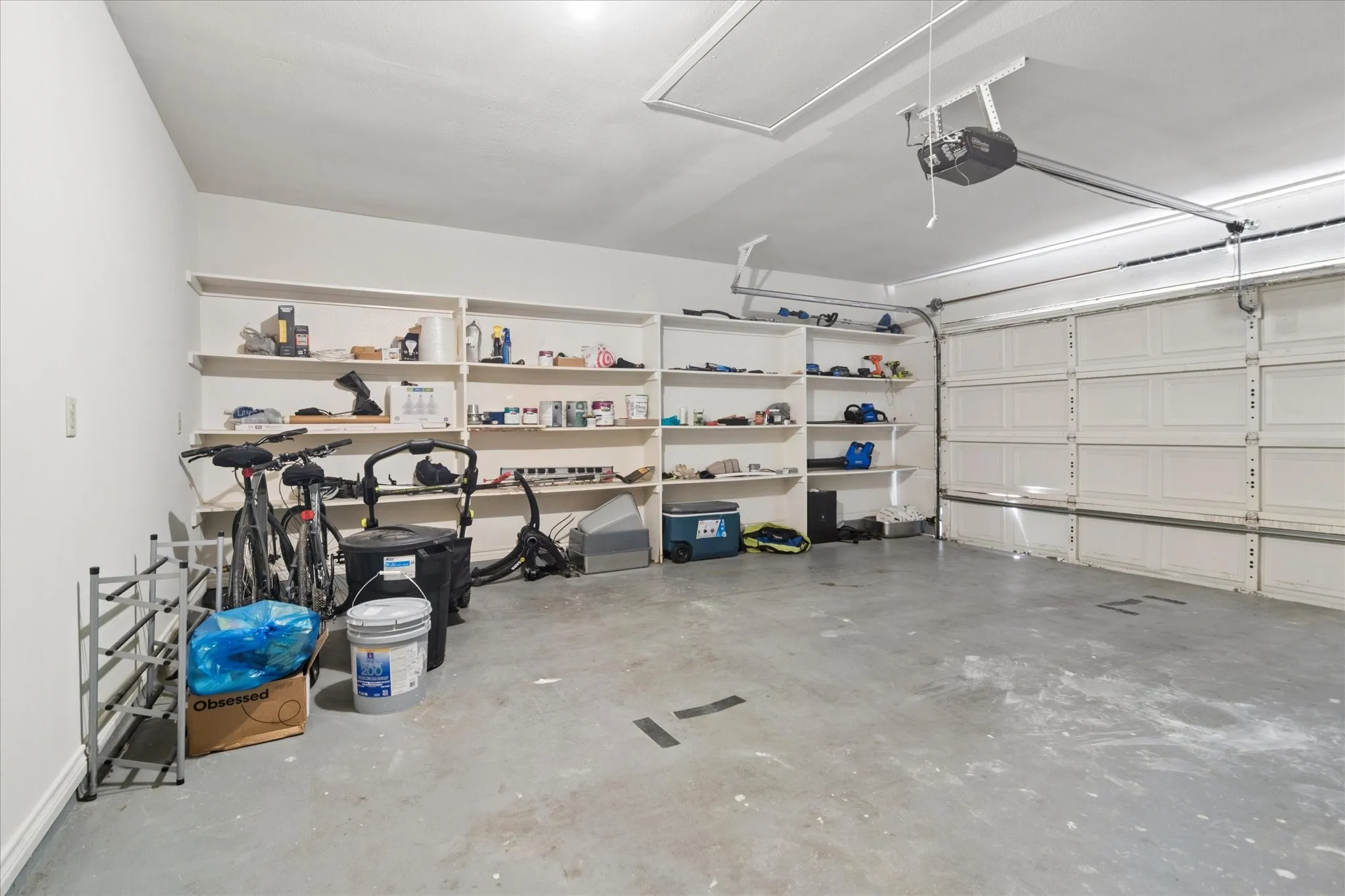 2-car garage includes shelves for organizing​​‌​​​​‌​​‌‌​‌‌​​​‌‌​‌​‌​‌​​​‌​​ tools