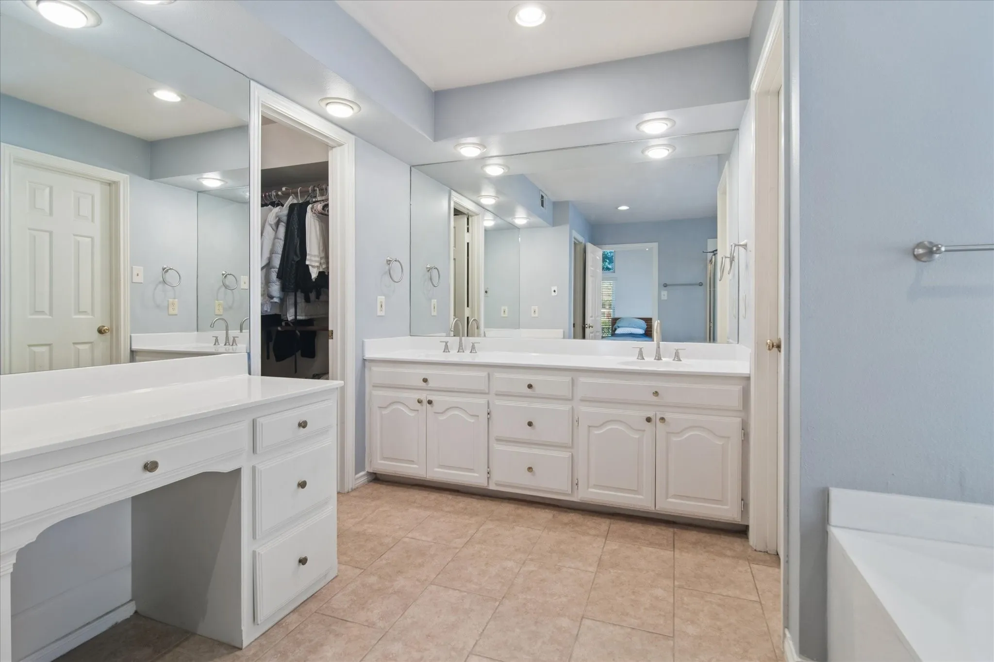 Double vanity has been refreshed with newly refinished countertops and pewter faucets