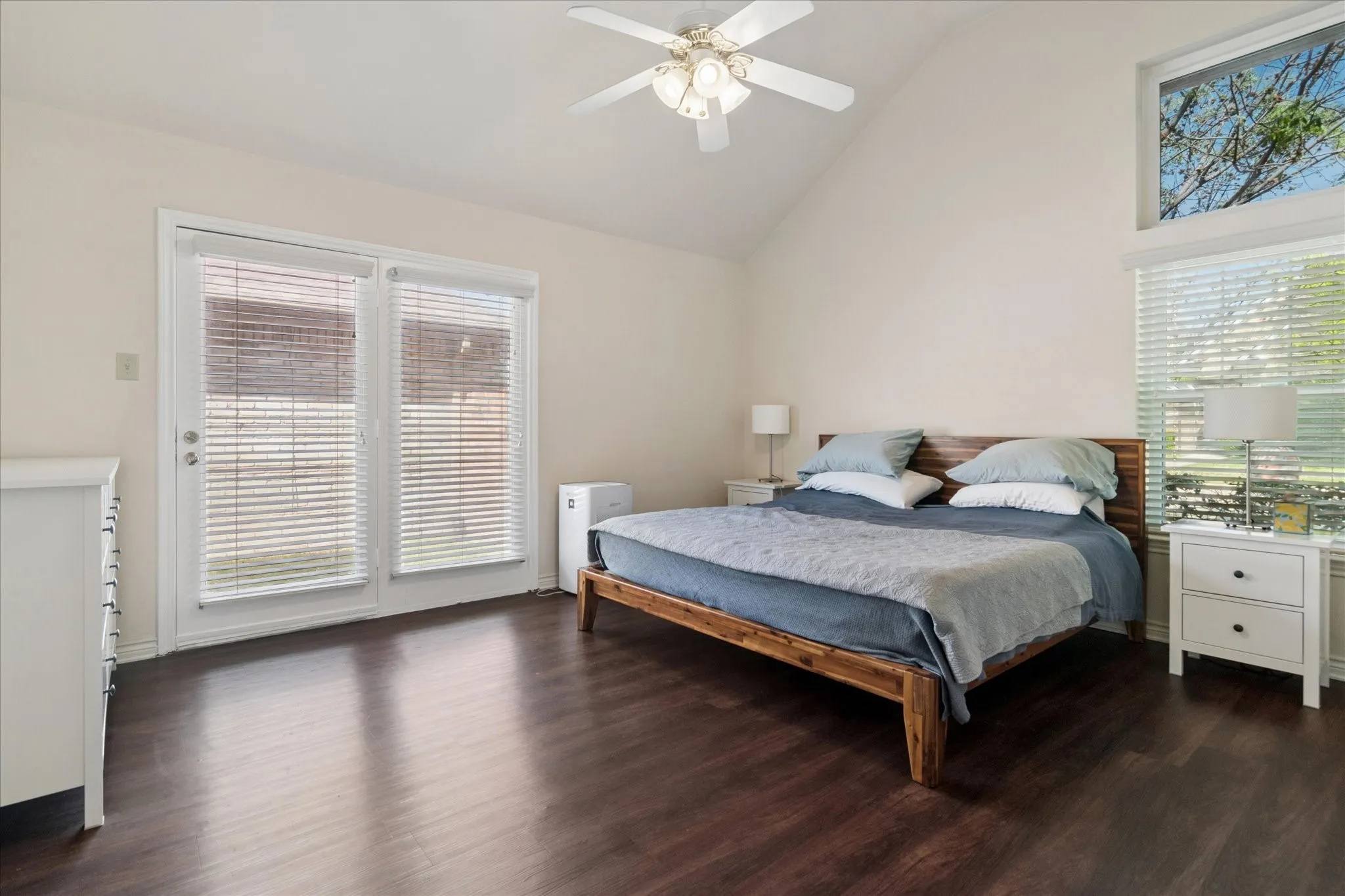 Newer wood luxury vinyl plank floors and glass doors to small courtyard in primary bedroom which has an ensuite bath.