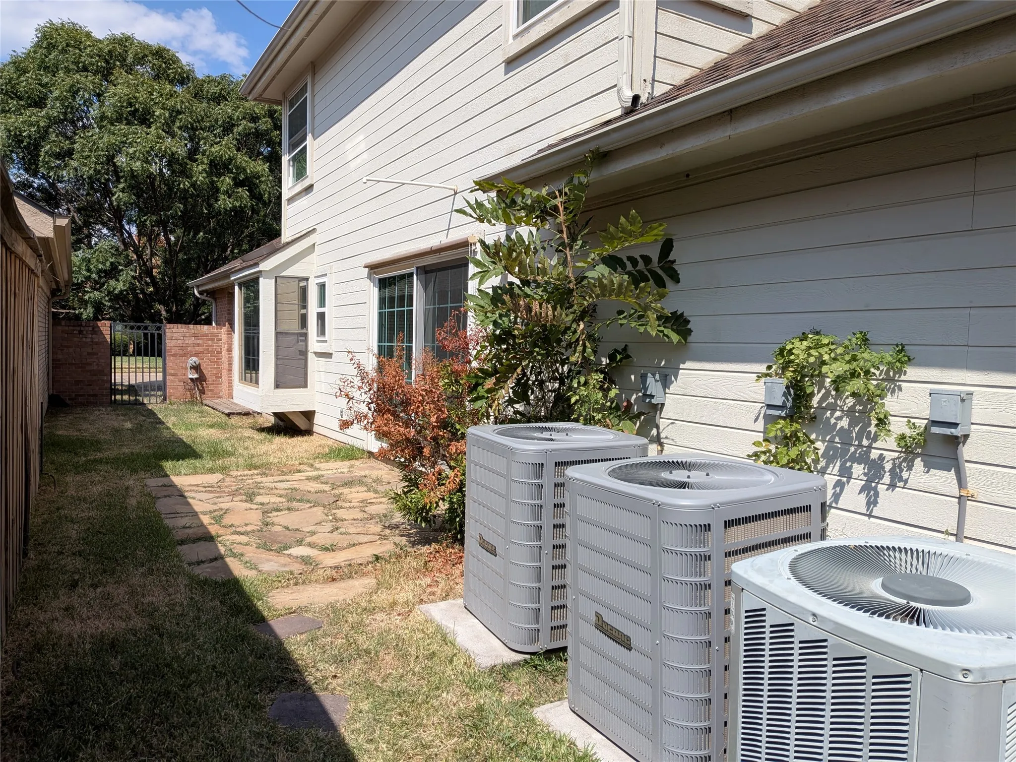 Two new AC compressors of three total keep the home cool on hot summer days.