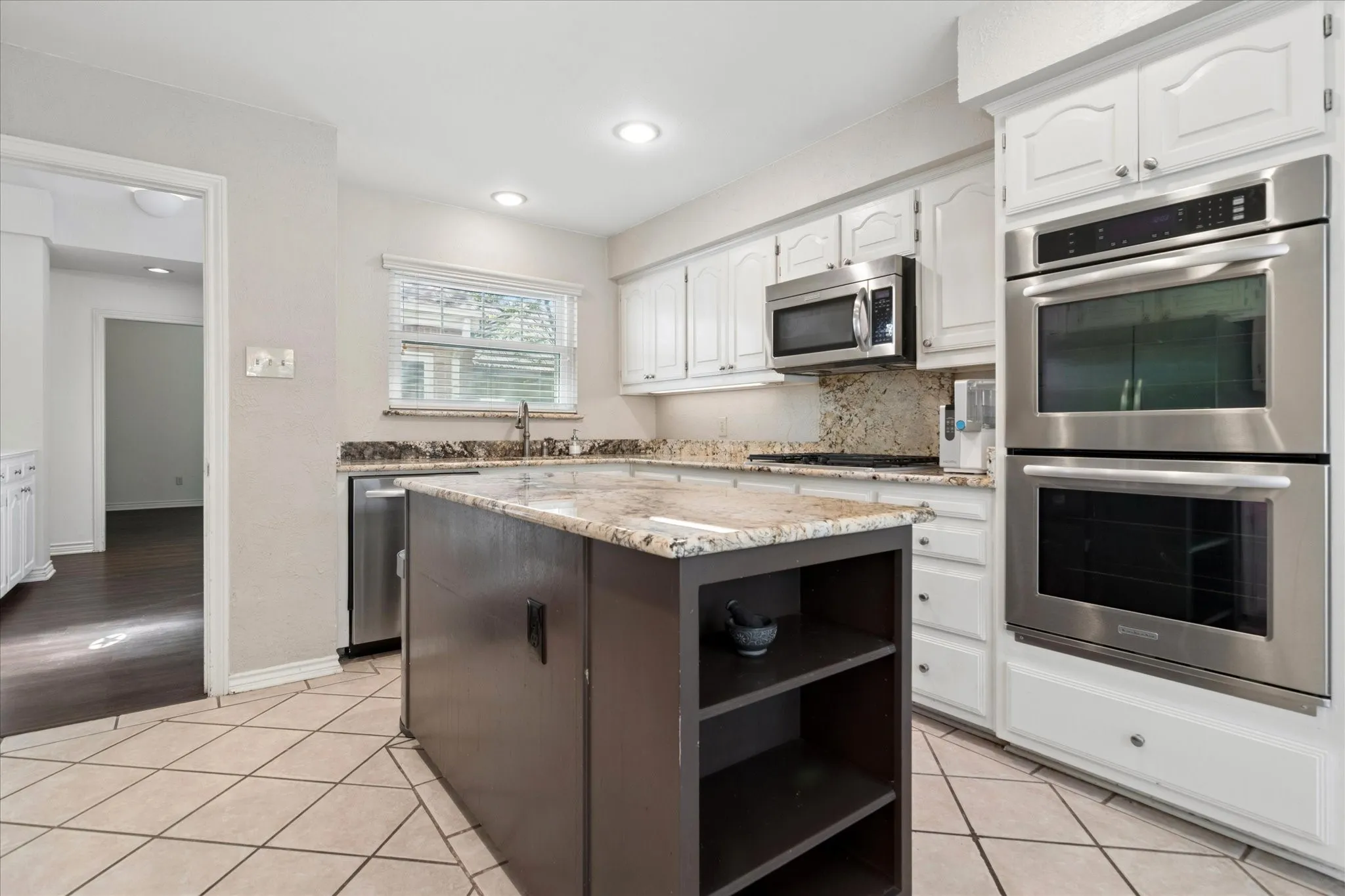 Kitchen is adjacent to the Great Room and includes double ovens and microwave