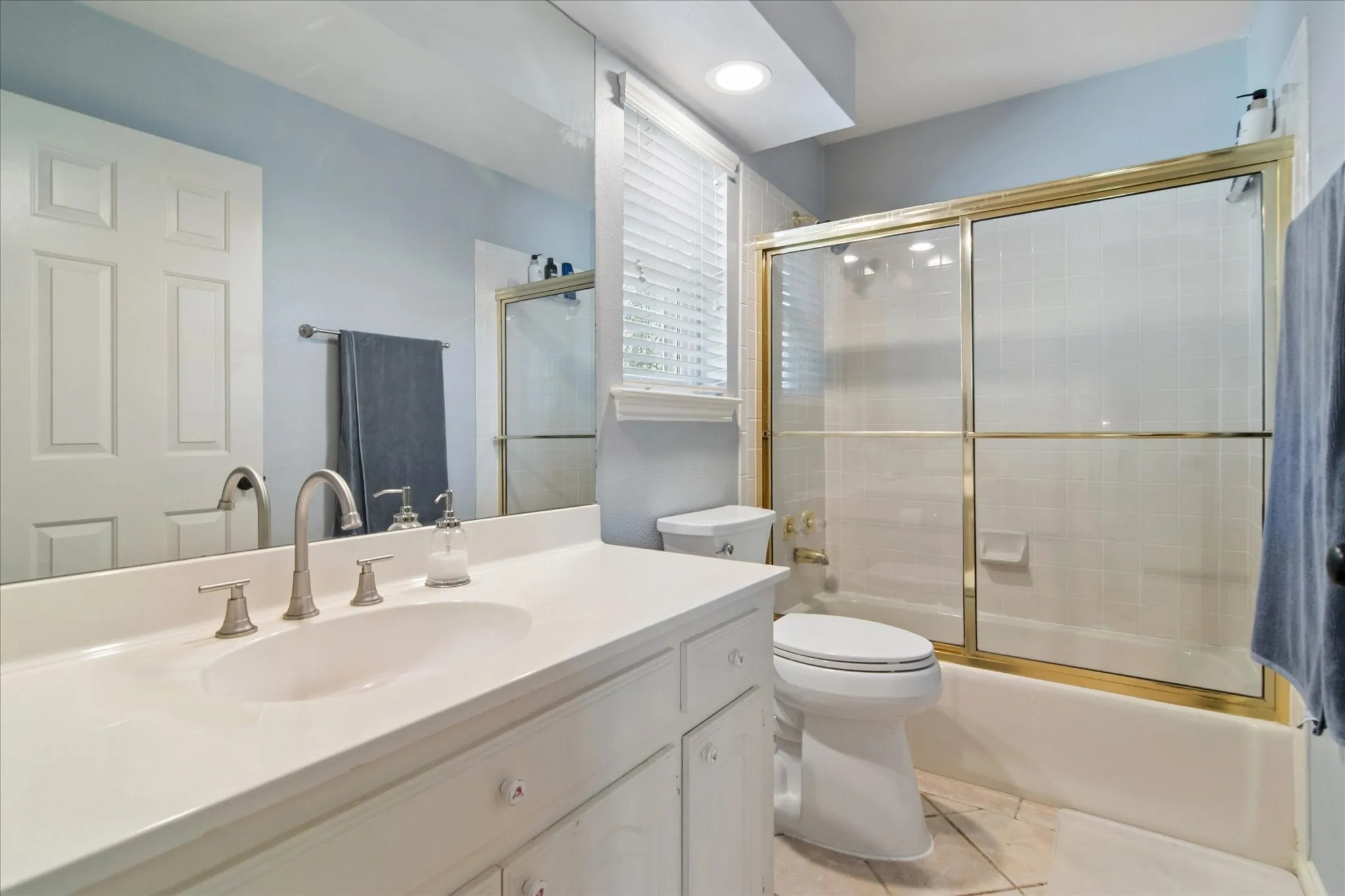 Upstairs Bathroom has shower tub with sliding enclosure