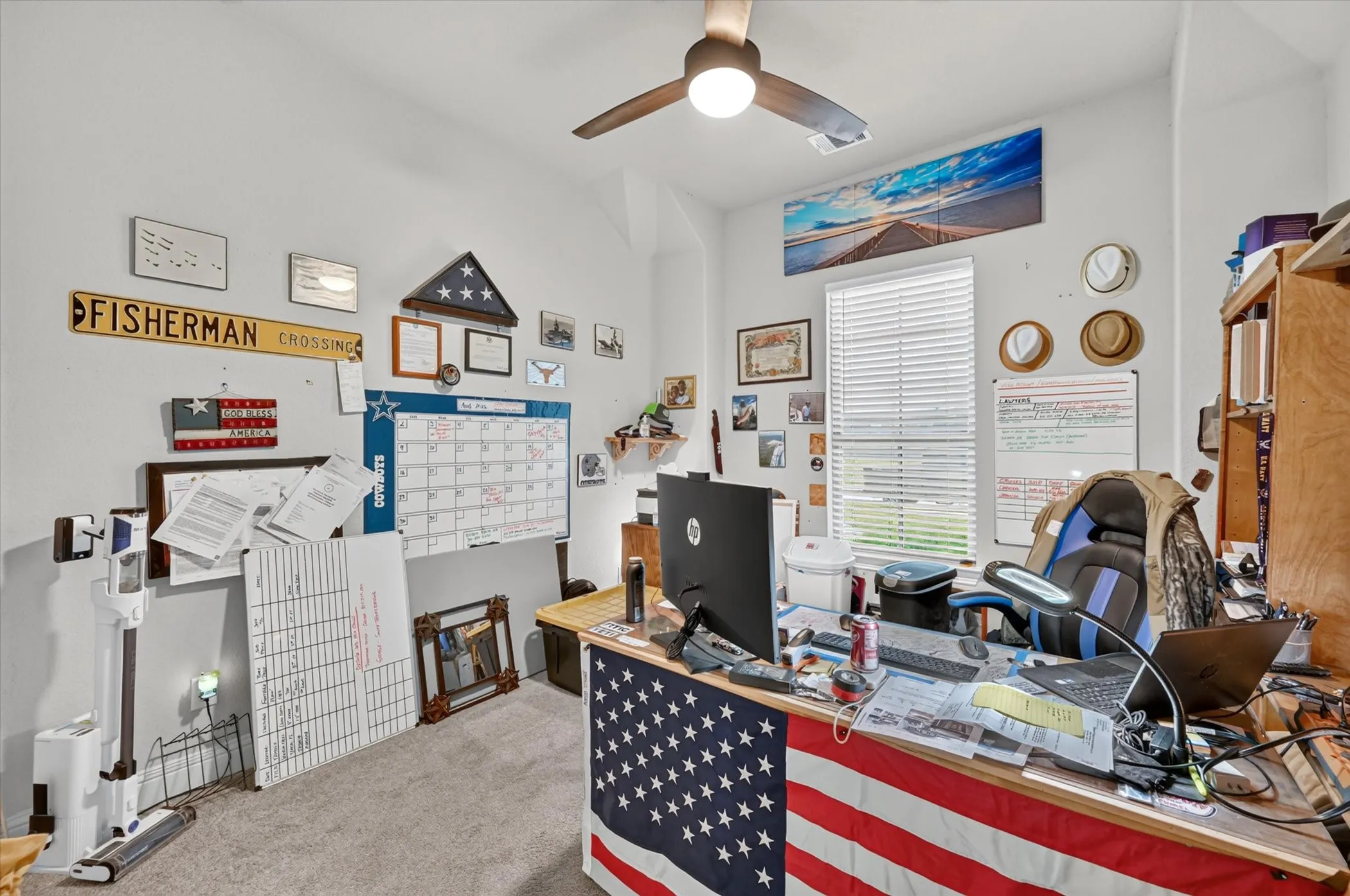 Recessed window with horizontal blinds, overhead ceiling fan with lighting, and light gray wall paint
