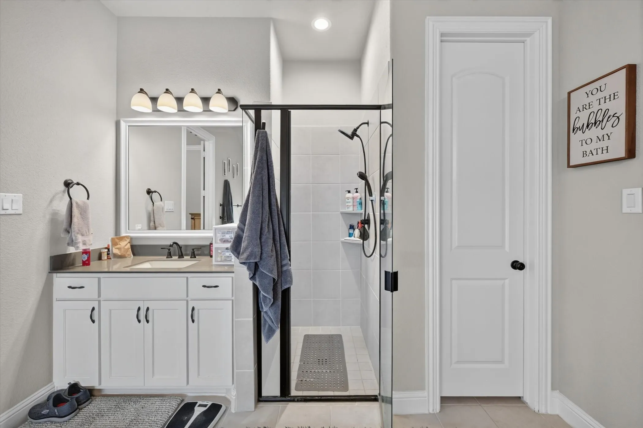 Contemporary vanity with a rectangular undermount sink and dark countertop