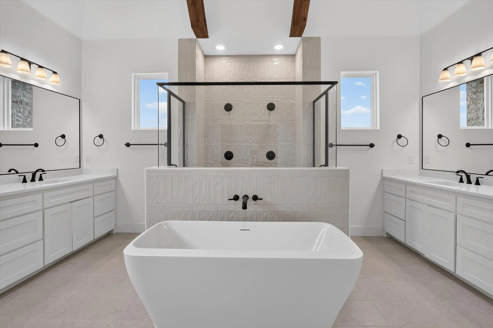 Freestanding soaking tub centered in a spacious bathroom