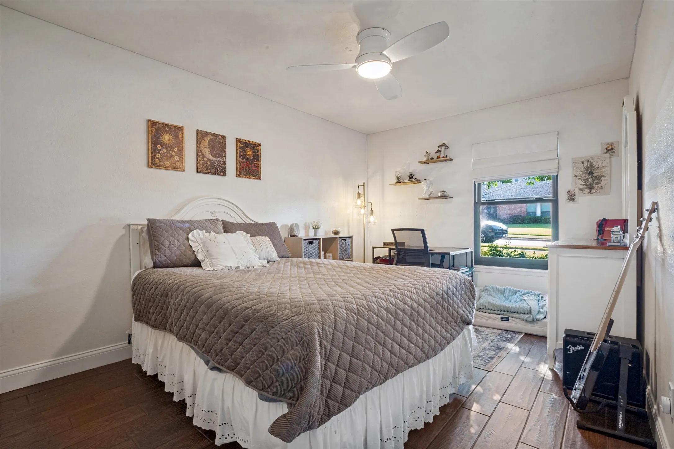 This secondary bedroom is very large and features porcelain wood like tile & a ceiling fan.