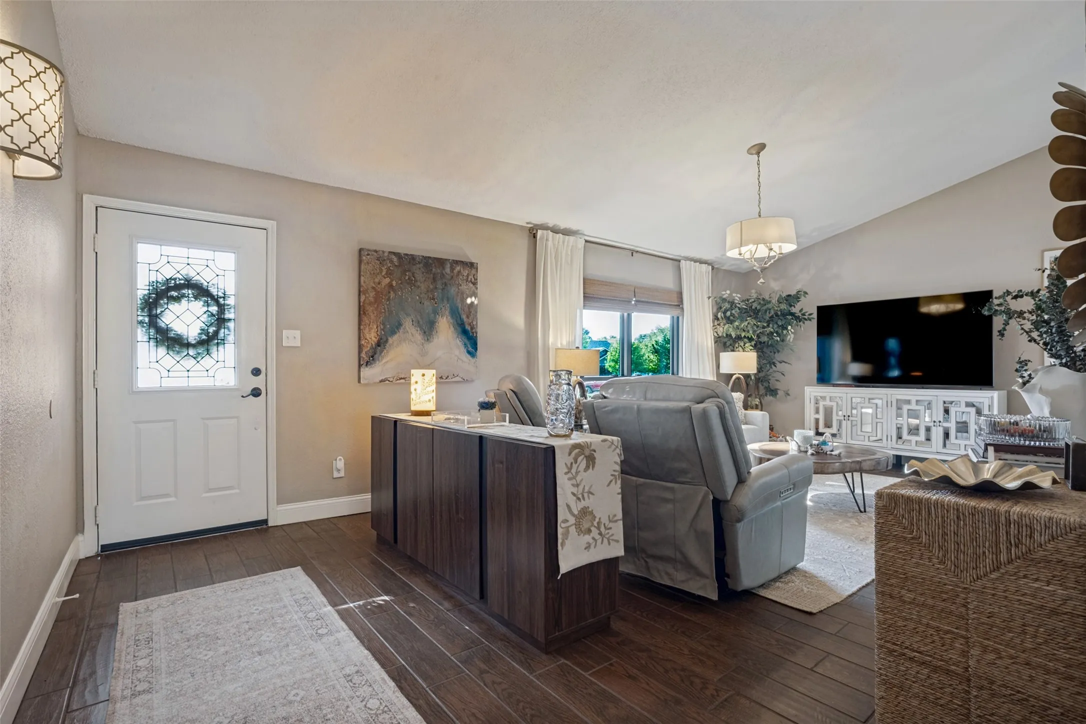 The light filled foyer & living area will delight you.  There is low maintenance, durable wood like tile that spans throughout most of the home.
