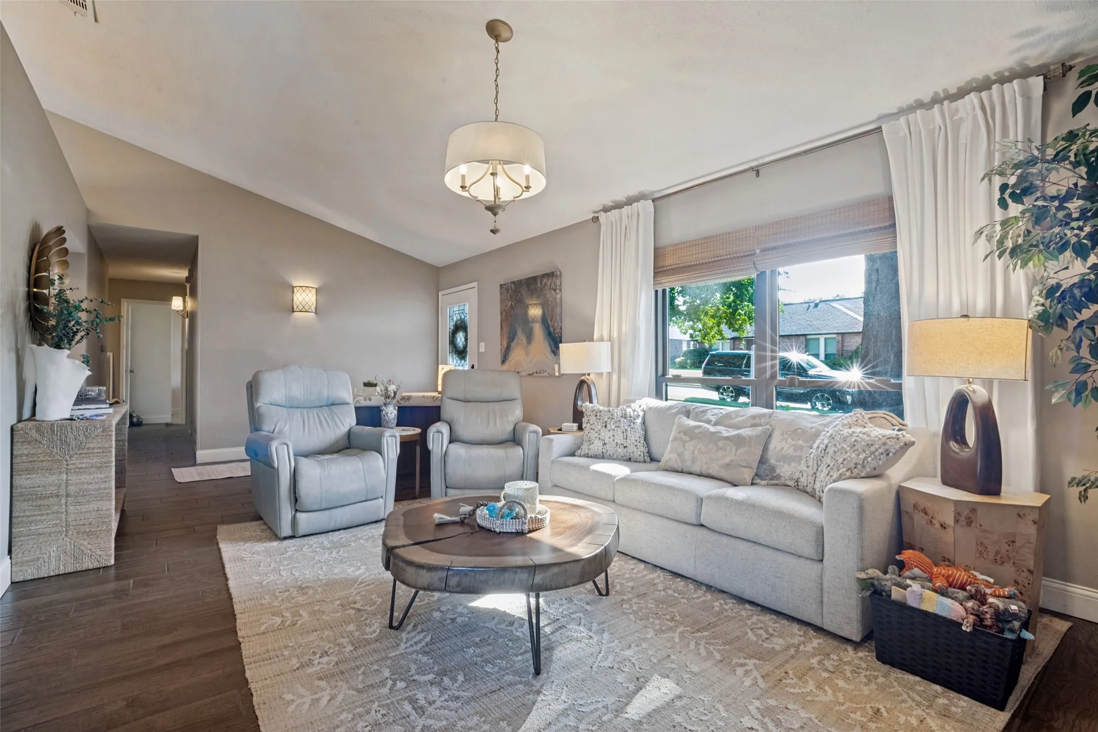 The living room is a wonderful place to sit and visit with friends or watch your favorite movies.  The room is adorned with a beautiful light fixture.