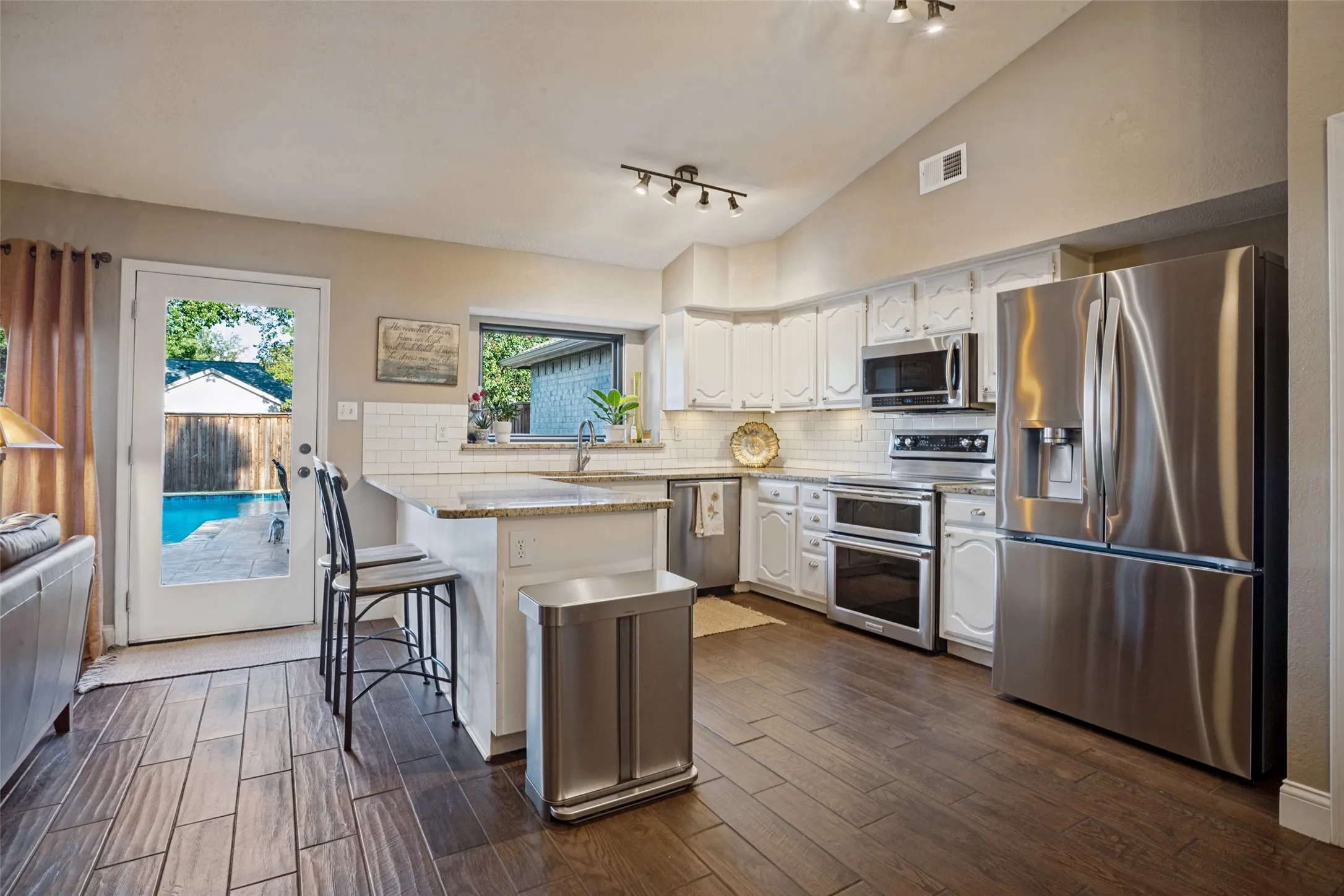 The kitche has been remodeled with granite countertops, subway tile backsplash & stainless steel appliances.