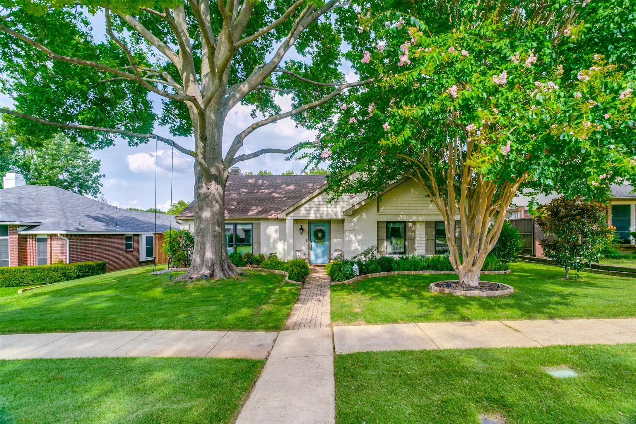 Beautiful drive up appeal!  Centuries old tree shades the entire front of the home.  Stone edged flower beds & professionally designed landscaping complete the package!