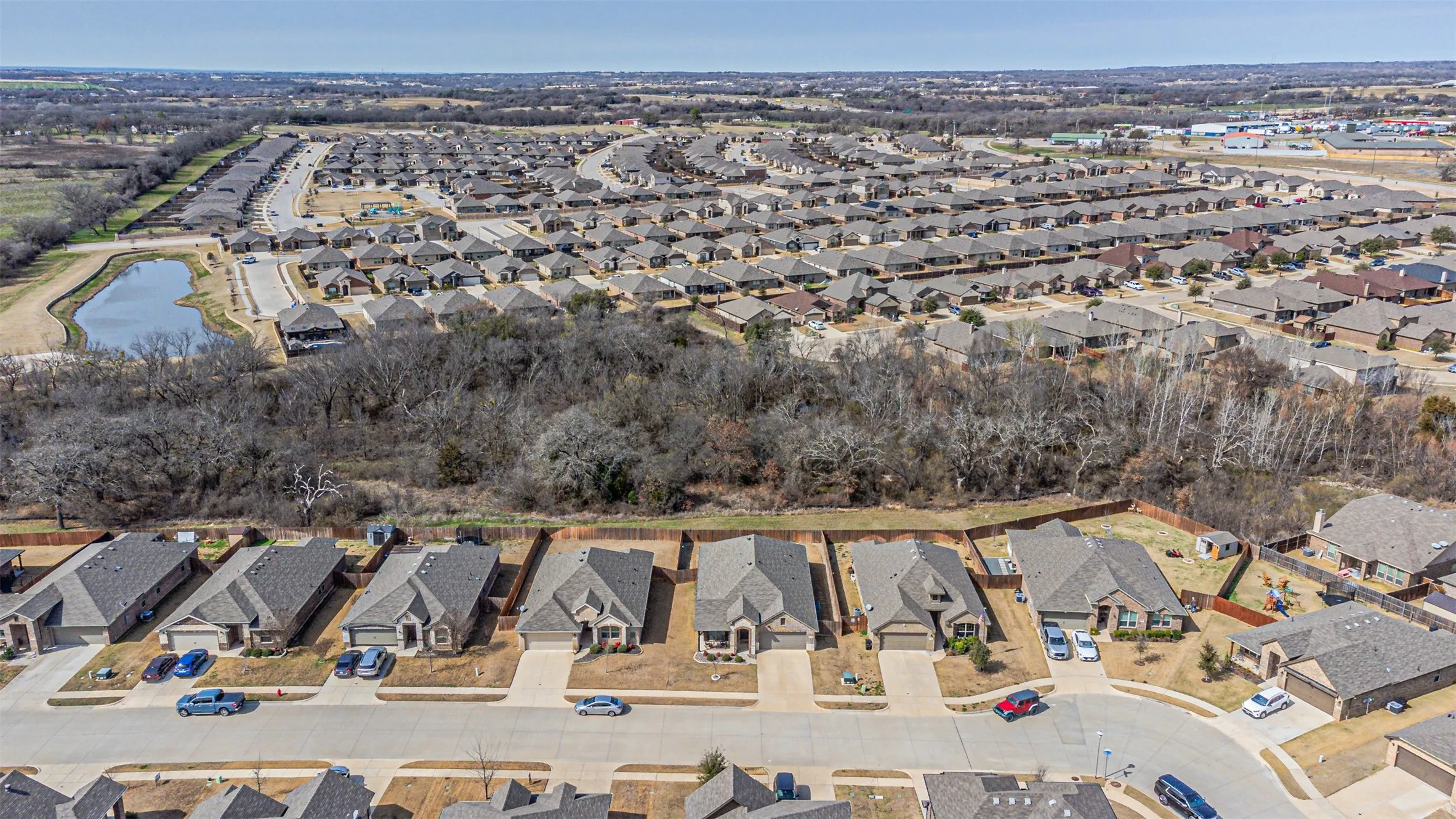 Aerial view of property's location with nearby suburban area