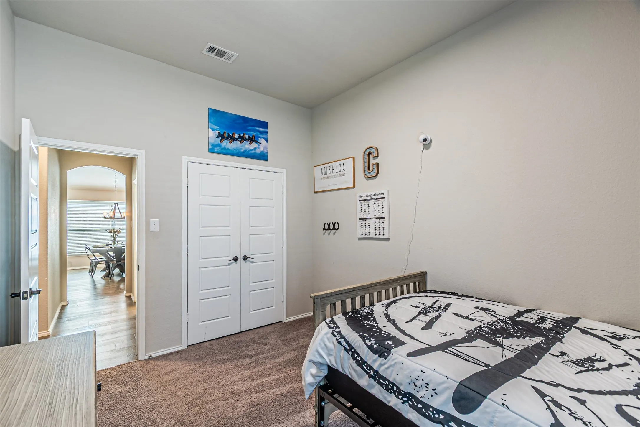 Bedroom with dark carpet and a closet
