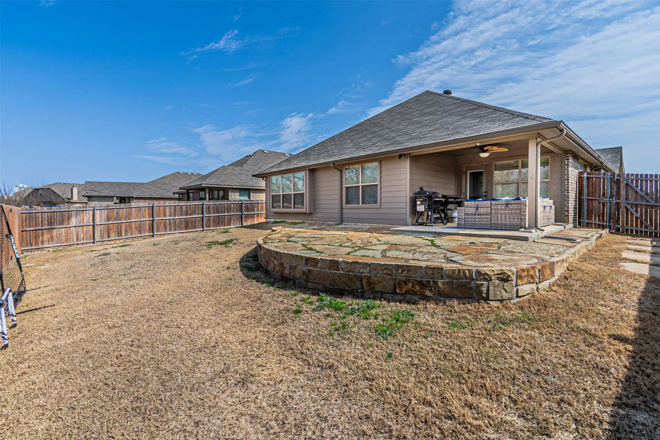 Back of property with ceiling fan, a fenced backyard, a patio, and a shingled roof