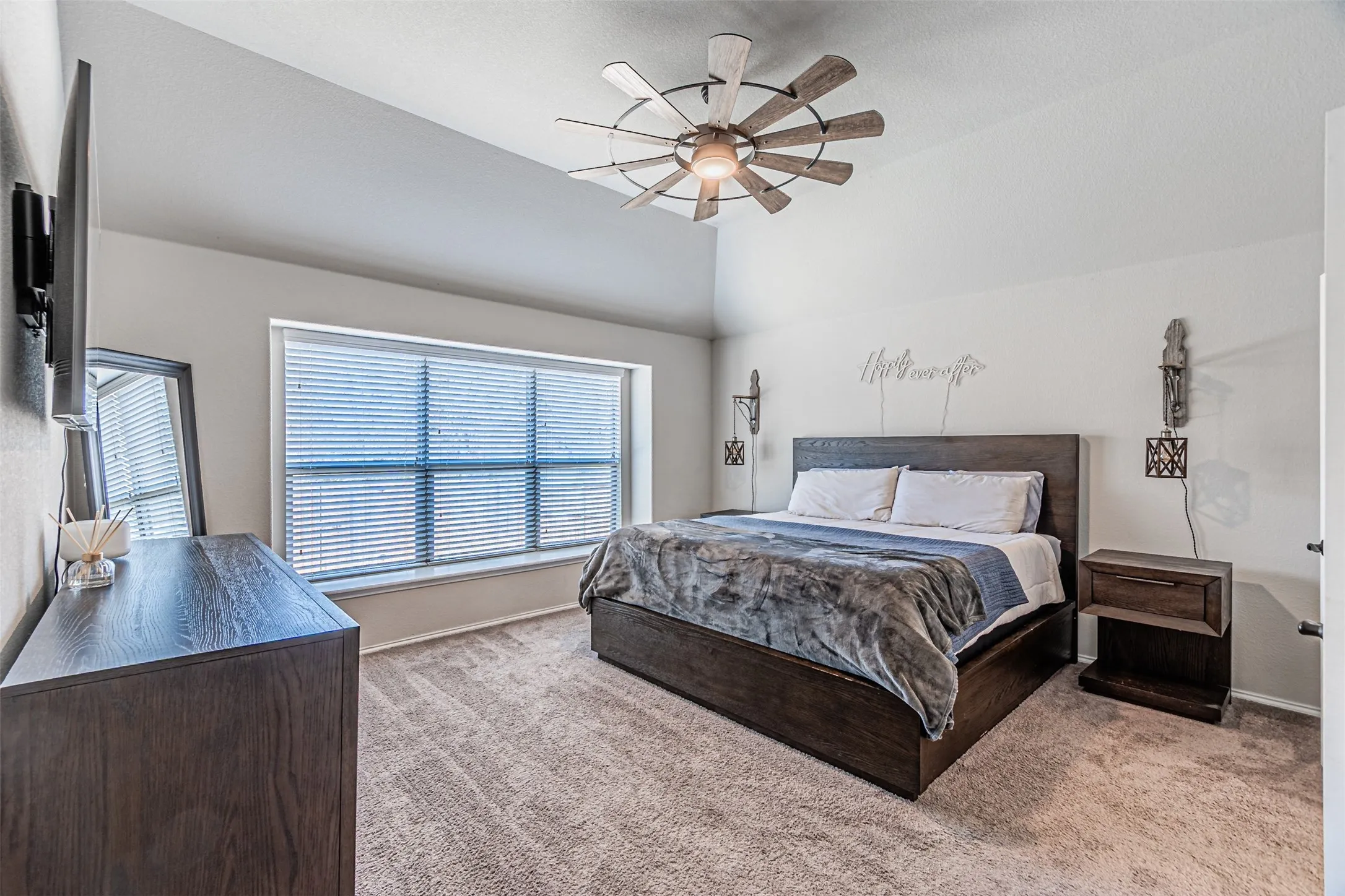 Bedroom featuring light colored carpet, ceiling fan, and lofted ceiling