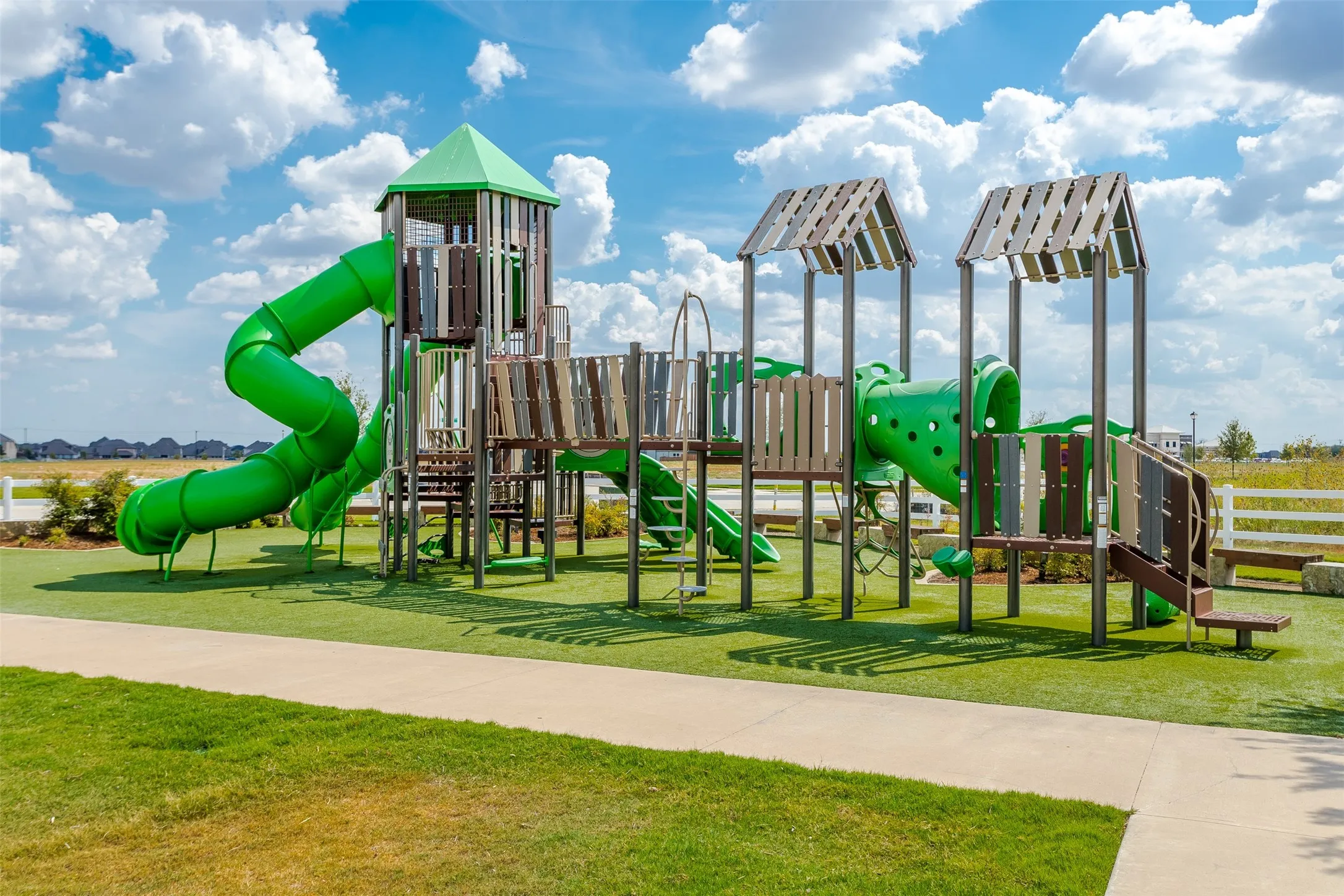 Playground featuring multiple slides, climbing structures, and a tower