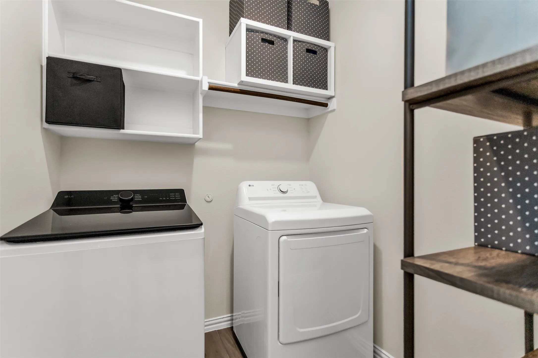 Built-in shelving, wood-finish flooring, and a clothes hanging rod