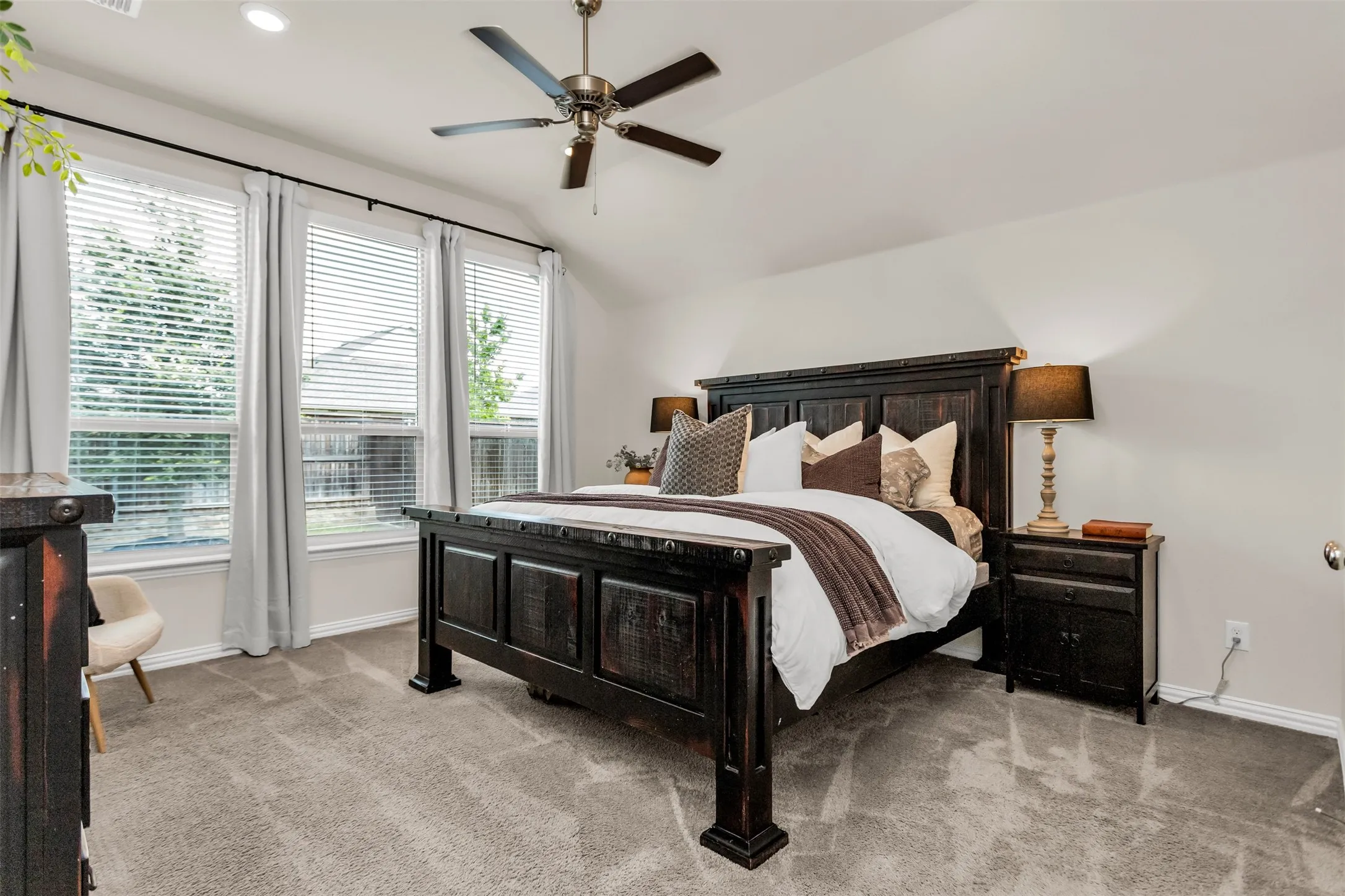 Vaulted ceiling, recessed lighting, and a ceiling fan
