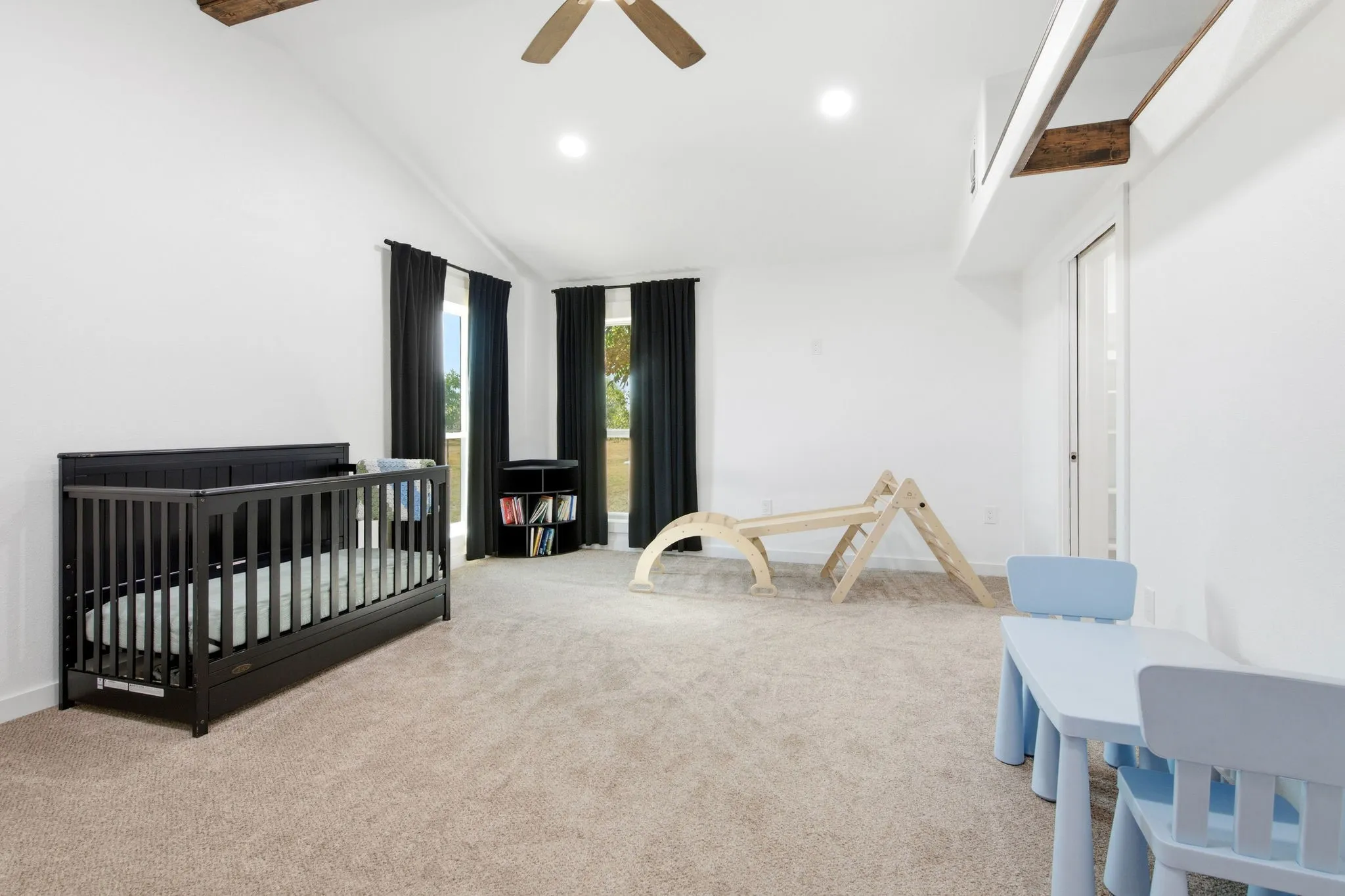 Vaulted ceiling with exposed wood beams, recessed lighting, ceiling fan, and carpeted flooring