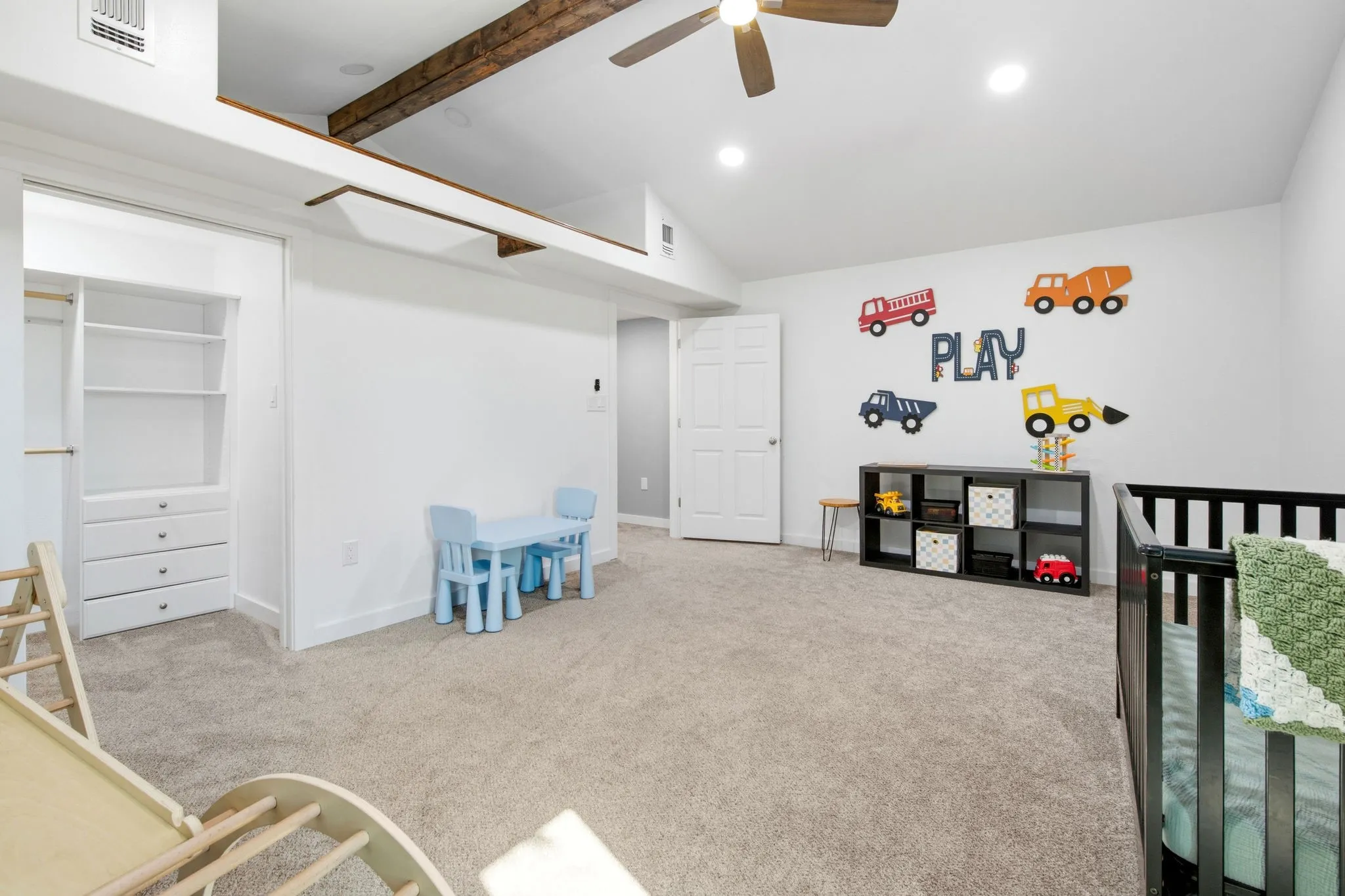 Vaulted ceiling with exposed wood beams, recessed lighting, and open closet